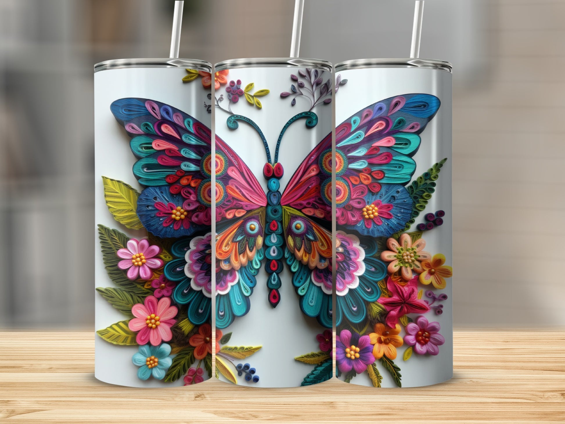 Three tumblers with a colorful butterfly and floral design.
