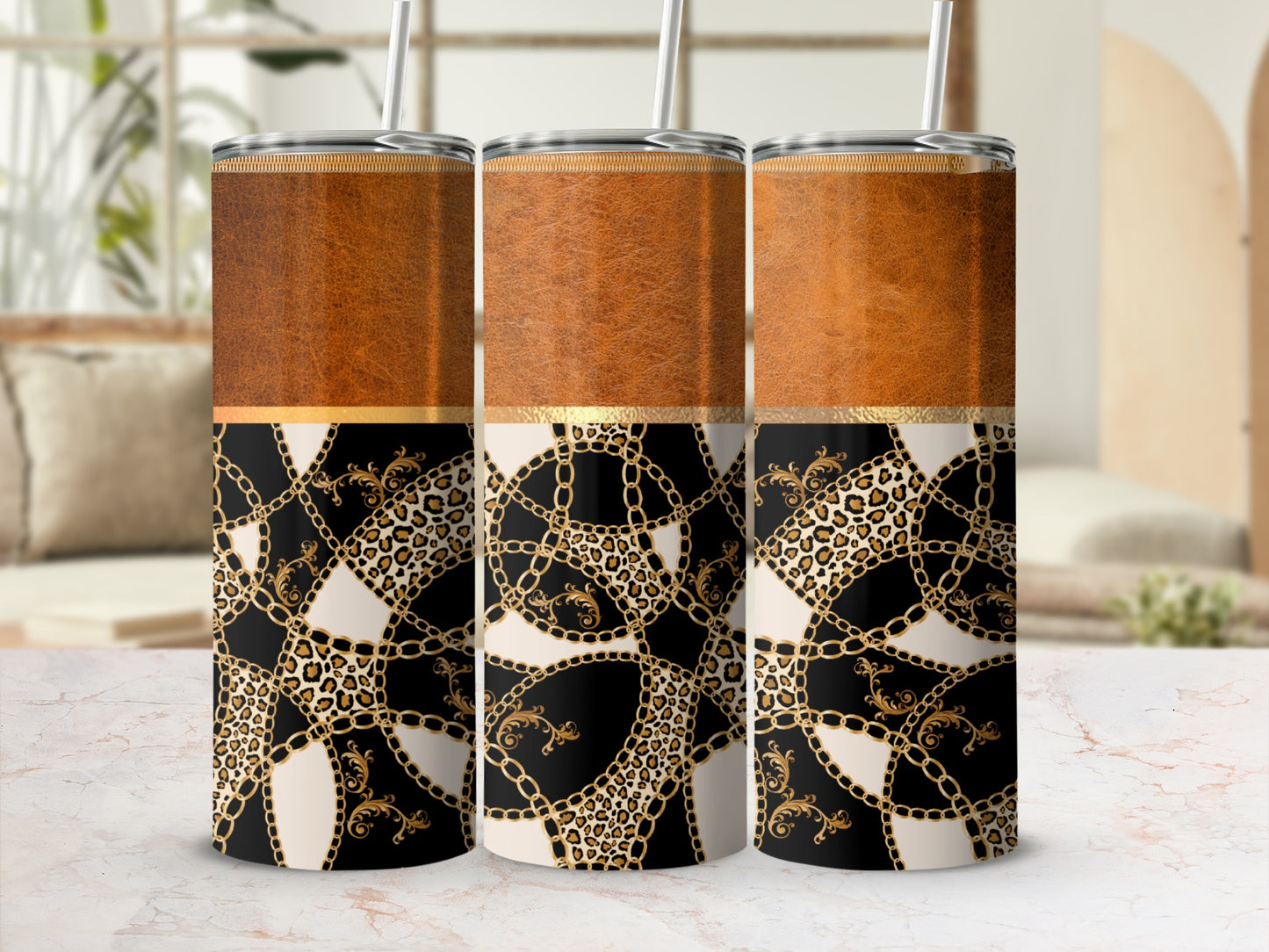 Three tumblers display a textured brown top band and a black, cream, and gold chain, leopard, and scroll pattern.