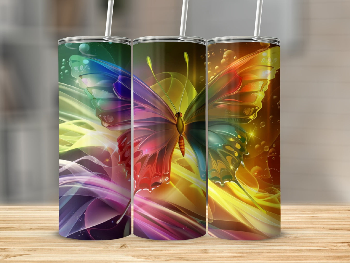 Three tumblers with colorful, iridescent butterfly designs and abstract, glowing backgrounds.