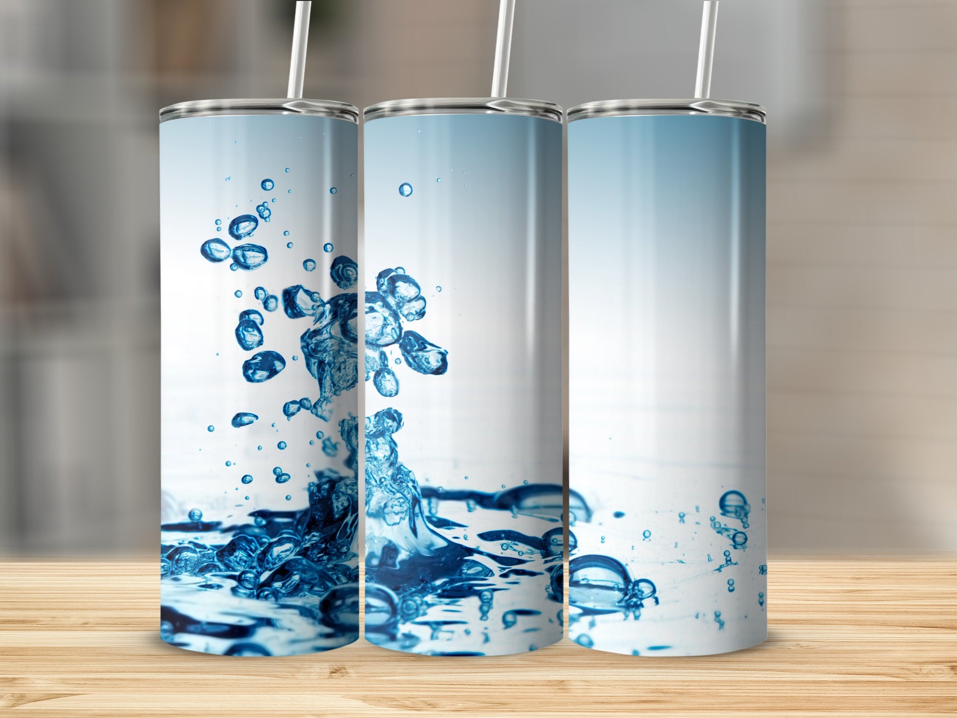 Three tumblers with splashes of water and bubbles.