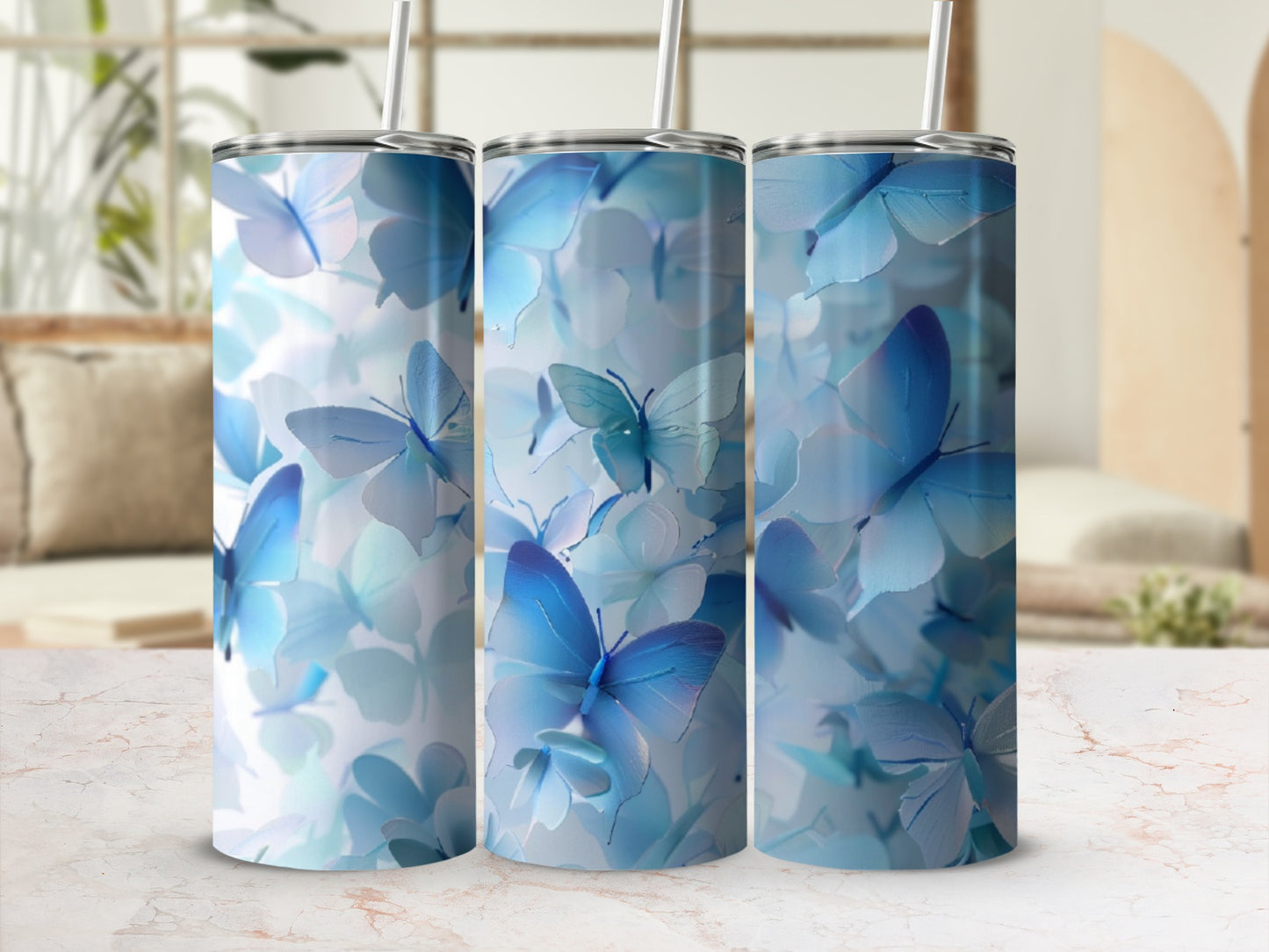Three tumblers featuring a blue butterfly and floral pattern.