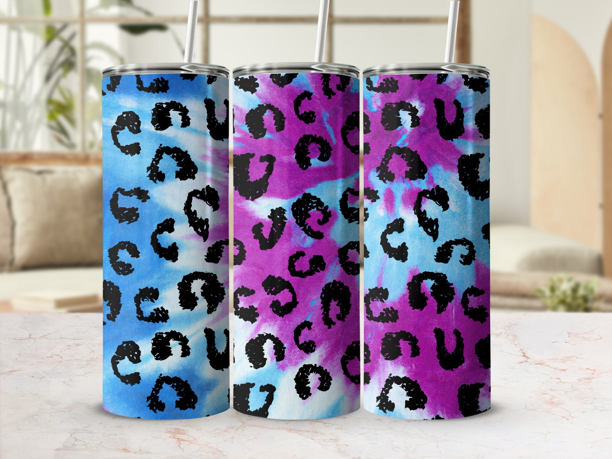 Three tumblers with blue and pink tie-dye pattern and black leopard spots.