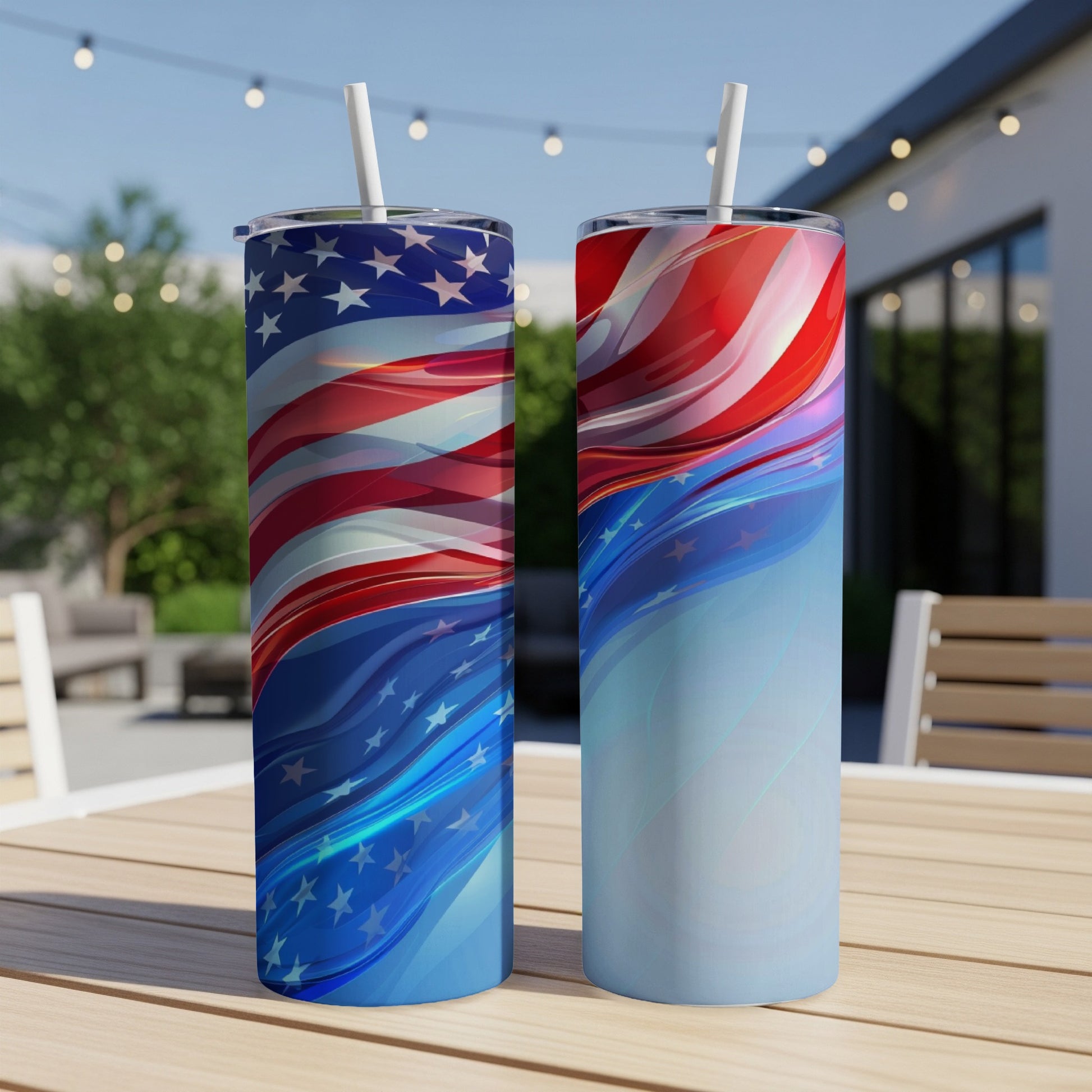 Two tumblers with American flag design and patriotic swirls on a table.