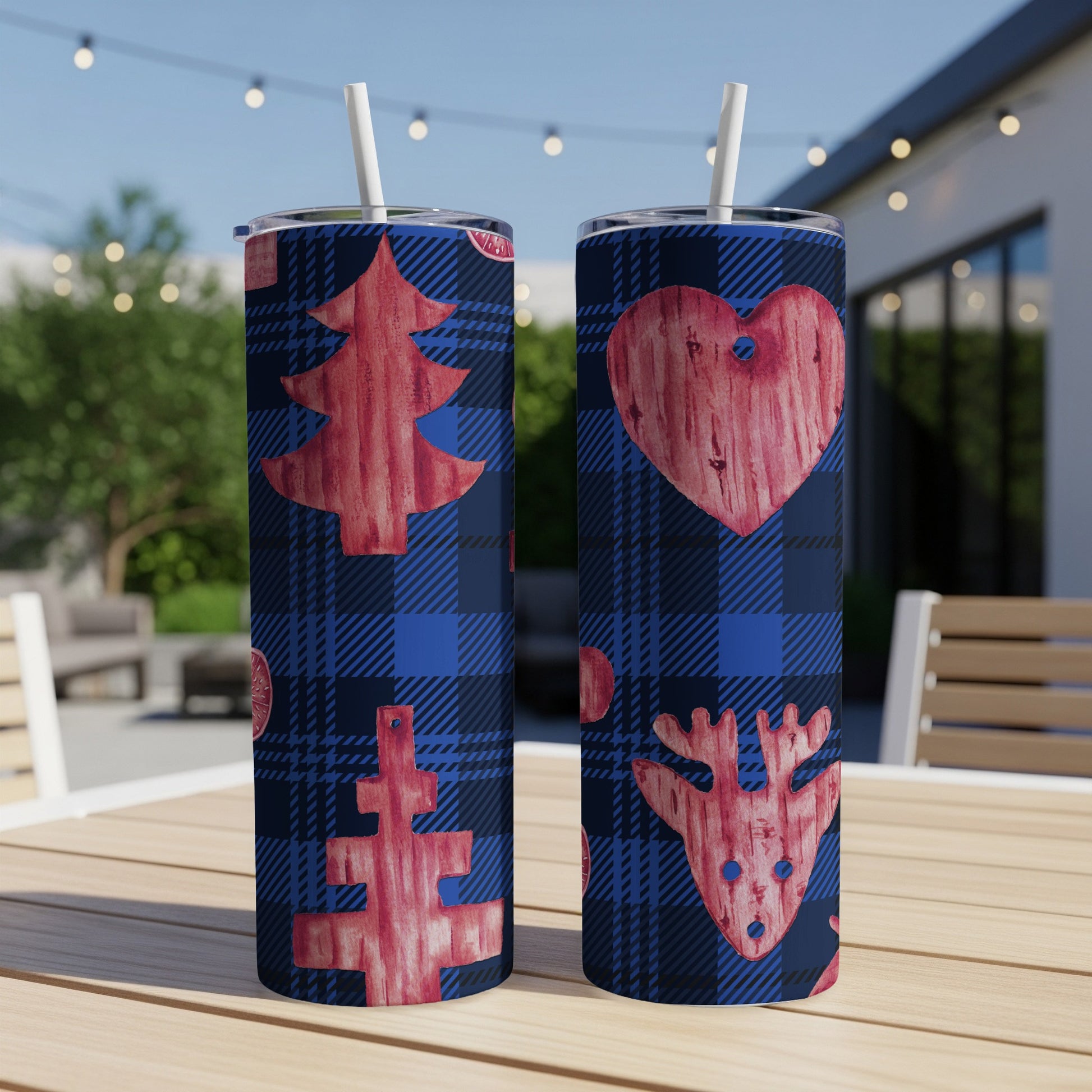 Two blue plaid tumblers with red Christmas tree and reindeer designs.