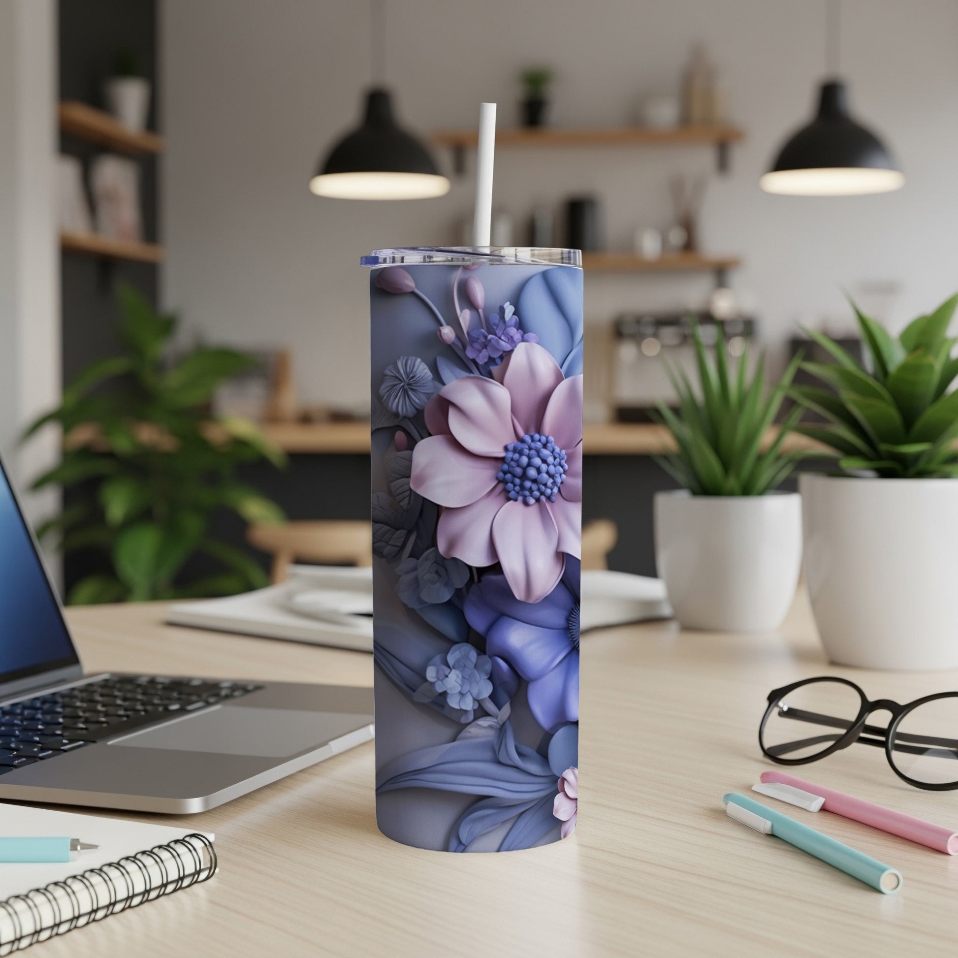 Purple floral tumbler with straw on a desk.