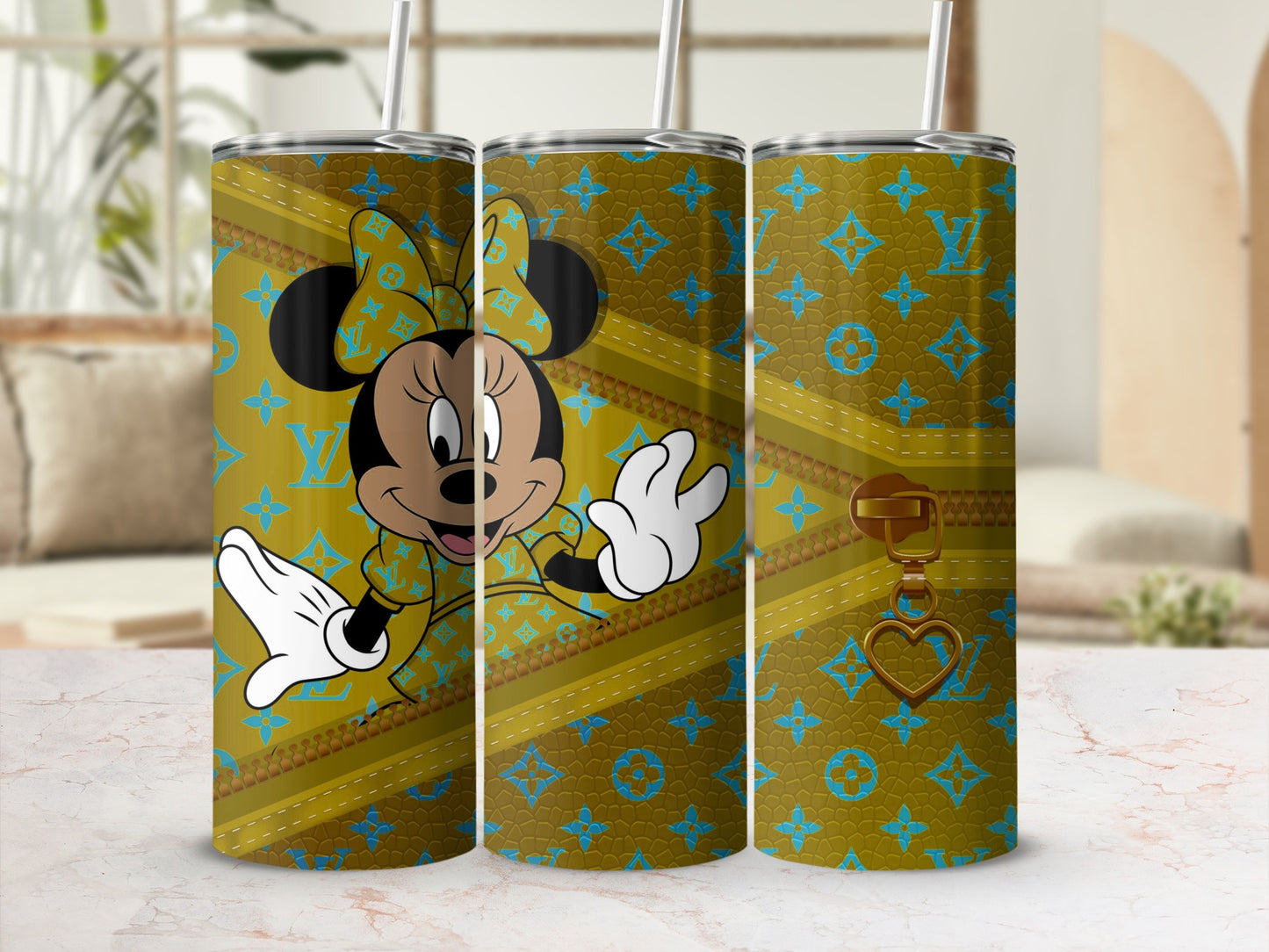 Minnie Mouse on a gold tumbler with a monogram pattern.