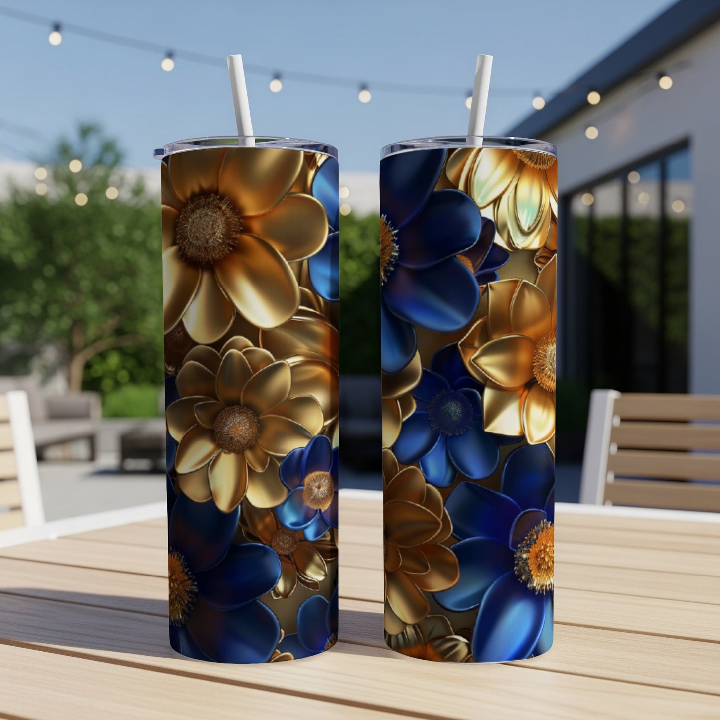 Two tumblers with blue and gold floral patterns sit on a table.