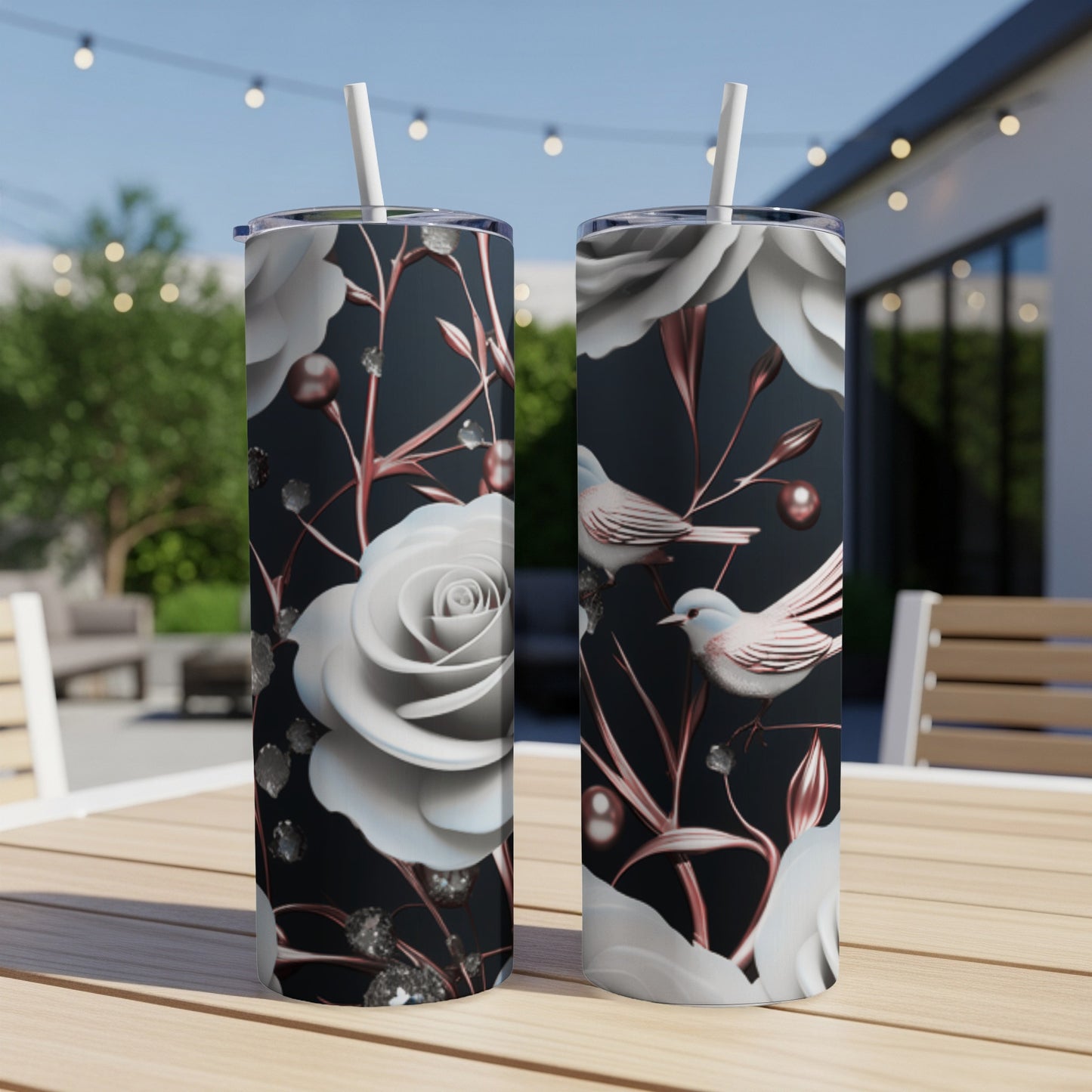 Two tumblers with a floral and bird pattern on a table.