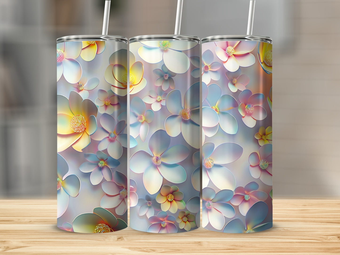 Three tall tumblers with a floral design of pastel-colored flowers.