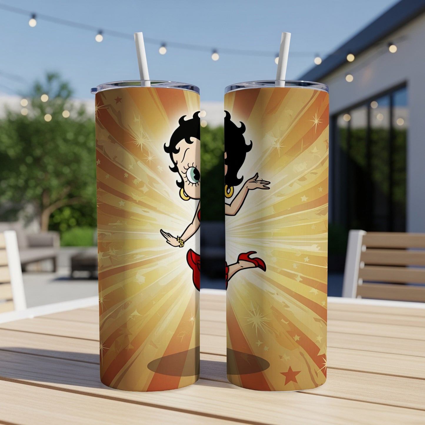Betty Boop on a gold starburst tumbler with a straw.
