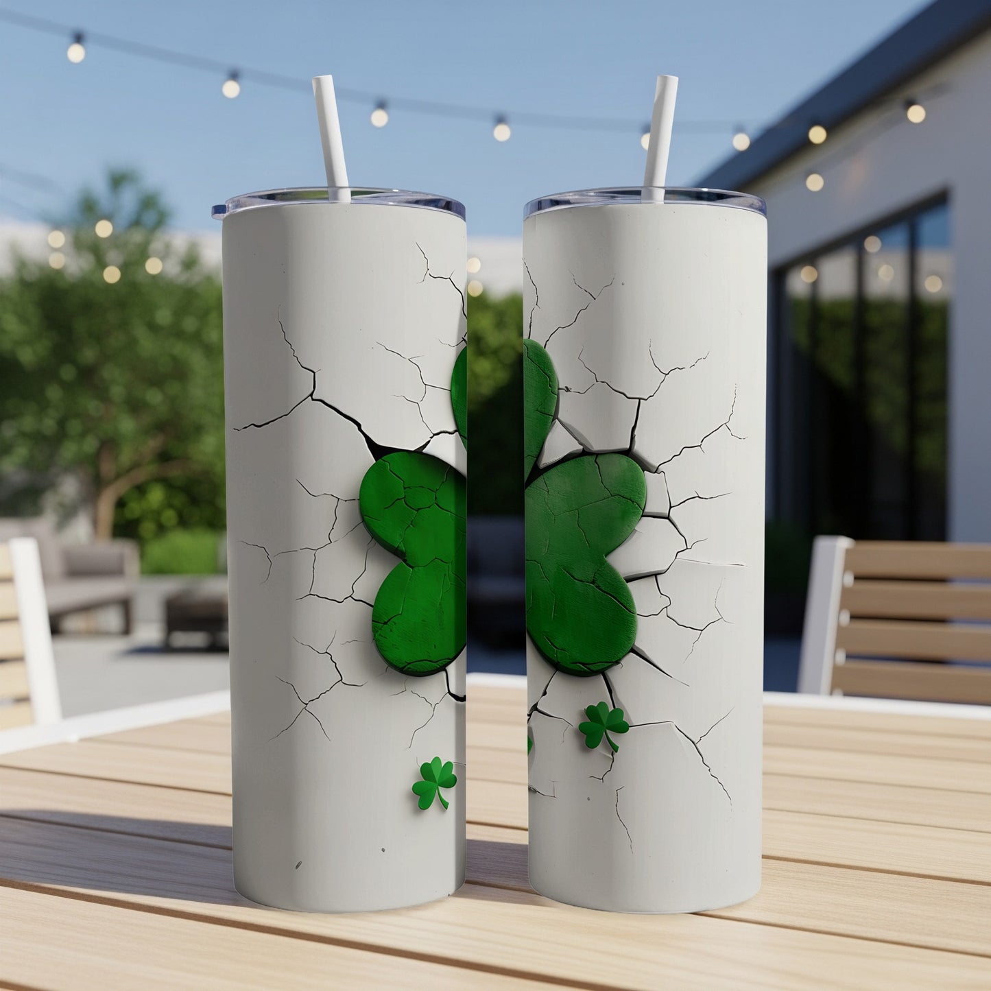 Two white tumblers with a cracked effect revealing a green shamrock design.