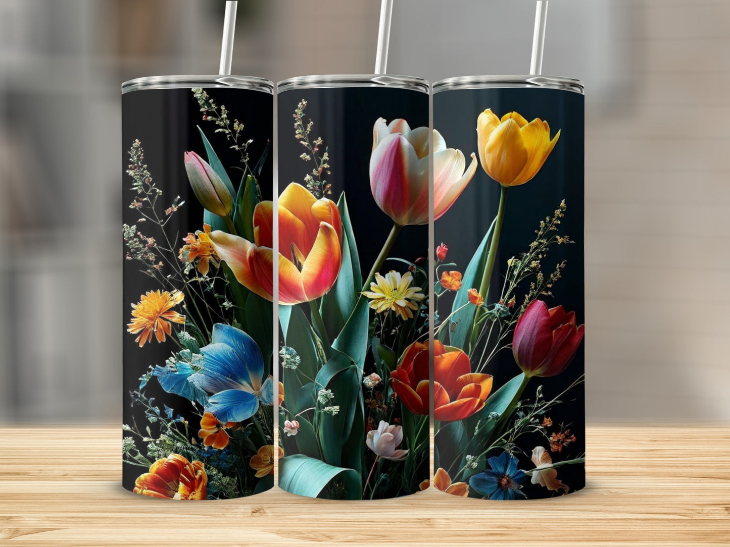 Three tumblers featuring vibrant floral arrangements with red, orange, and blue flowers.