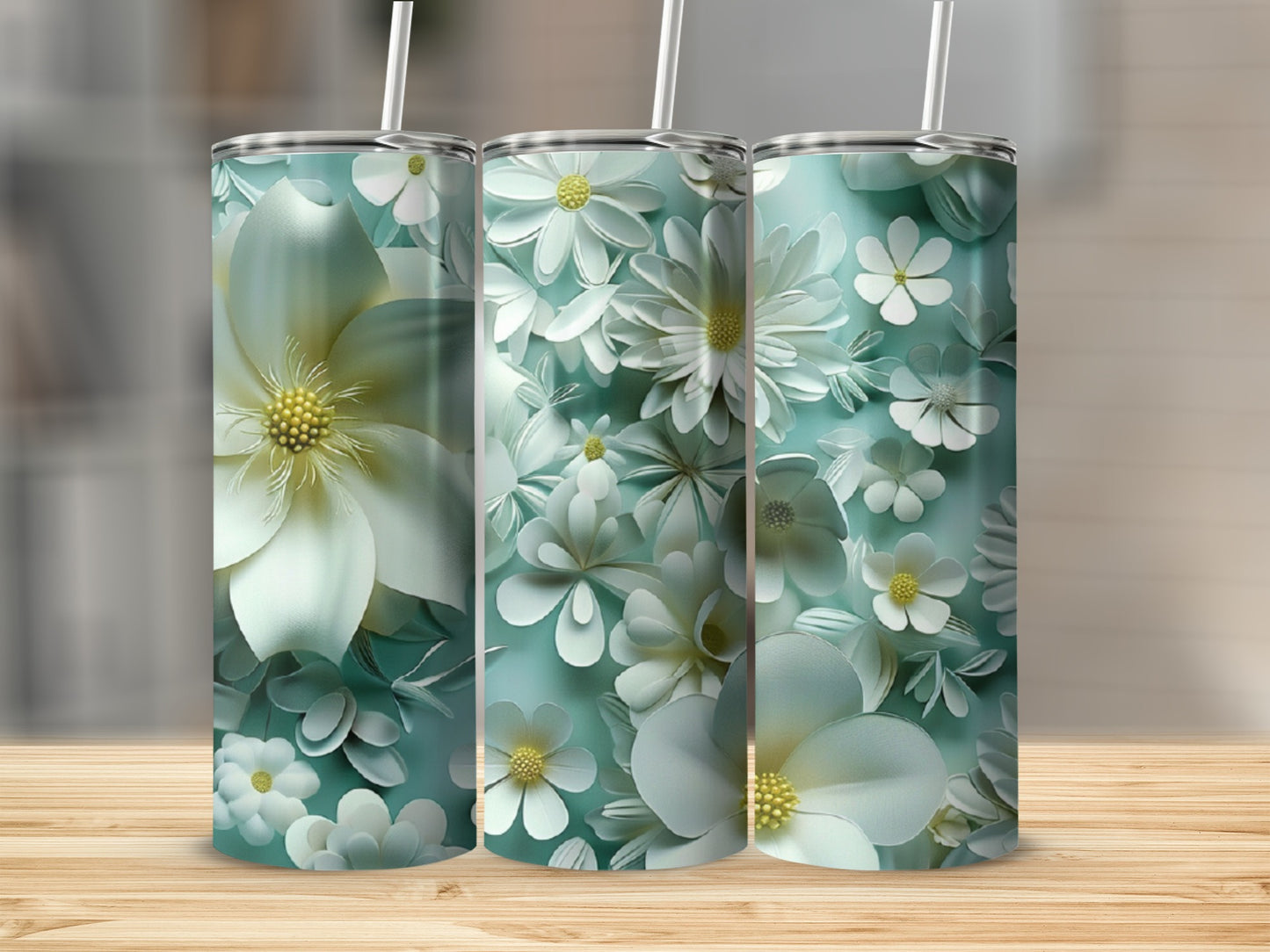 Three skinny tumblers featuring a white floral pattern on a teal background.