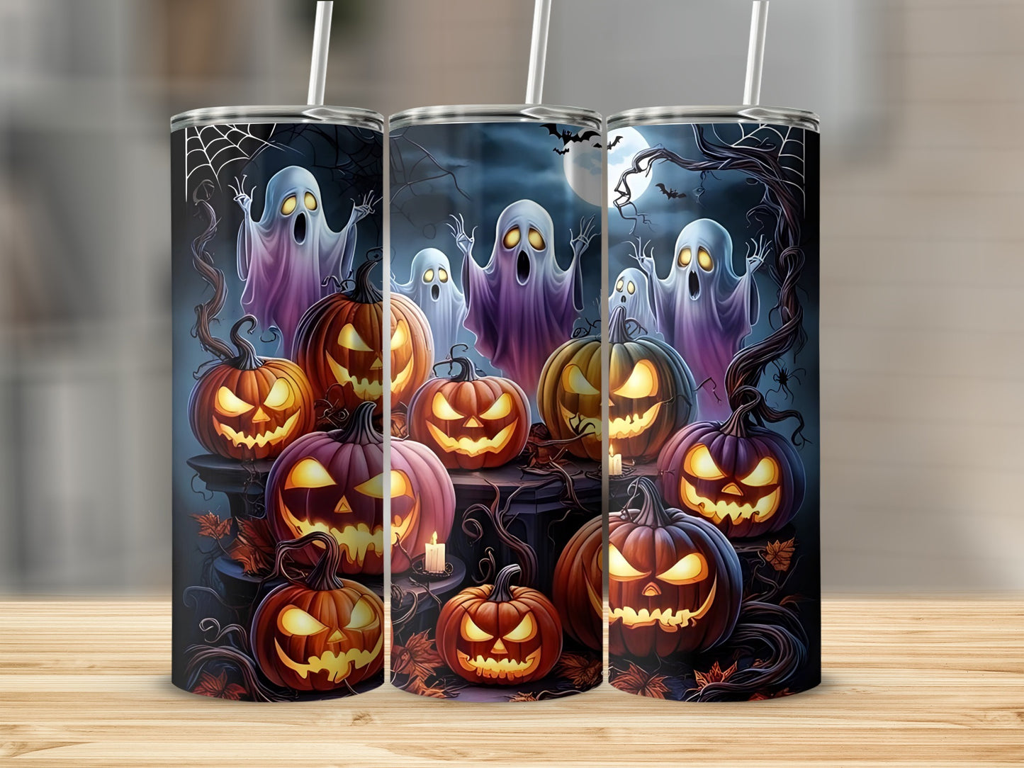 Three tumblers with a spooky Halloween design of ghosts and jack-o'-lanterns.