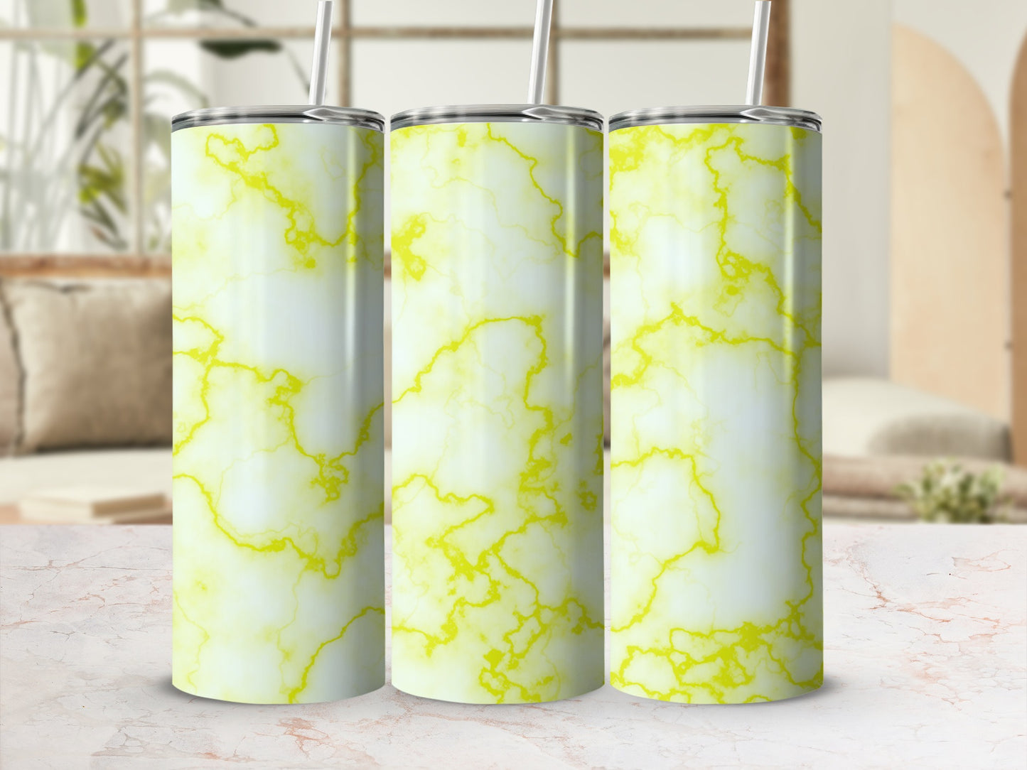 Three tumblers with a white and yellow marble pattern and straws.