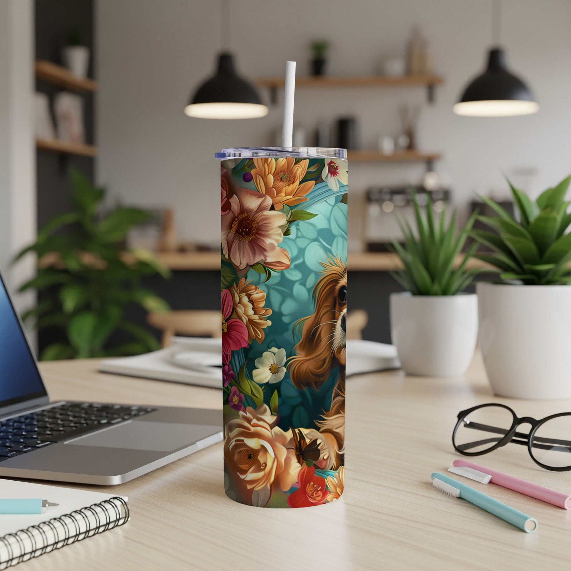 Floral tumbler with a dog's face, on a desk.