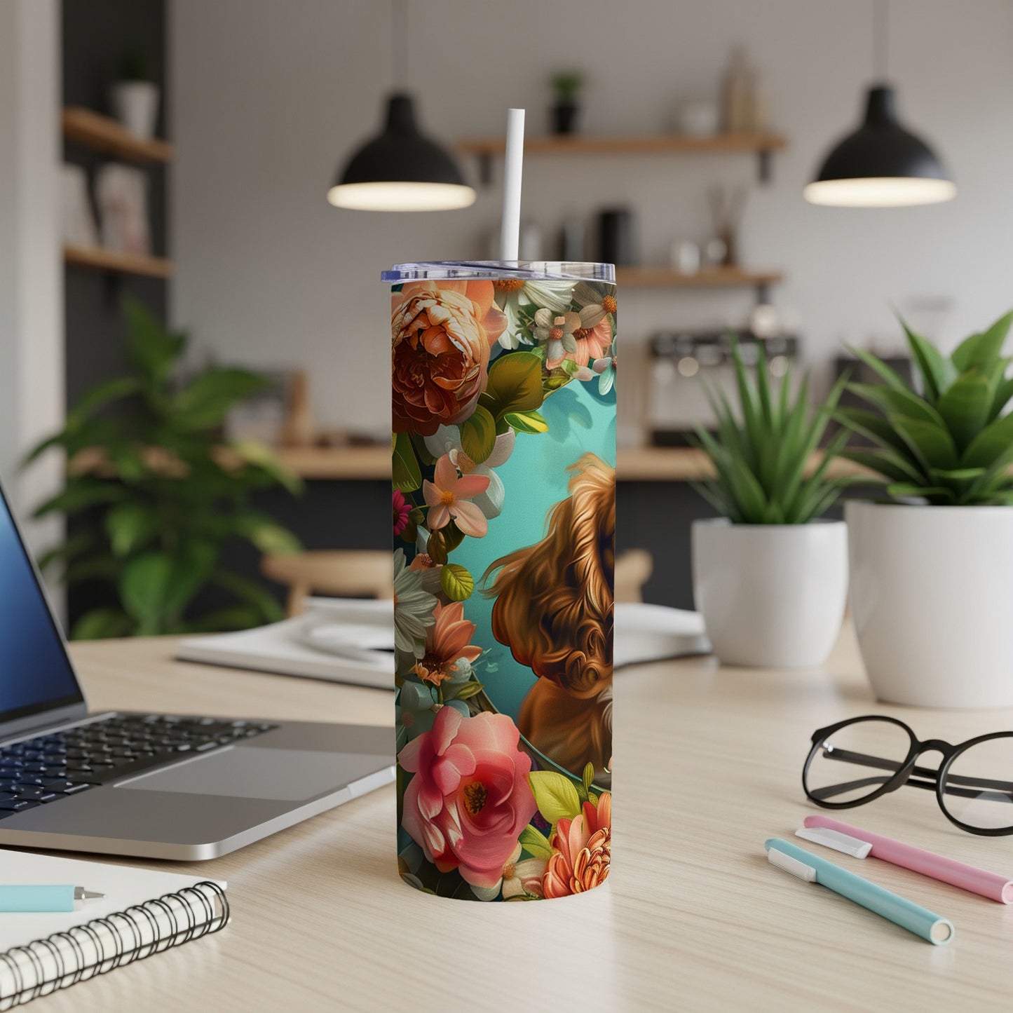 Floral tumbler with Cocker Spaniel design on desk.