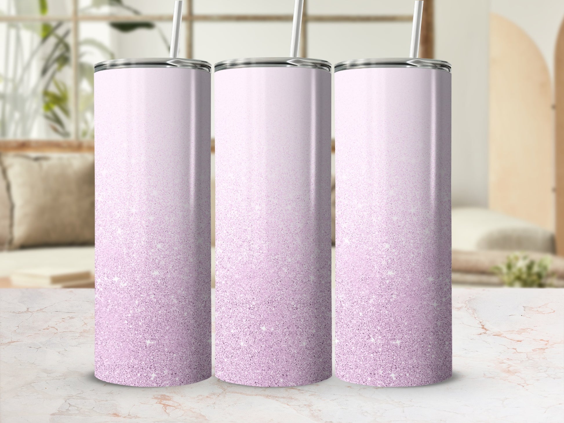 Three pink glitter gradient tumblers with straws.