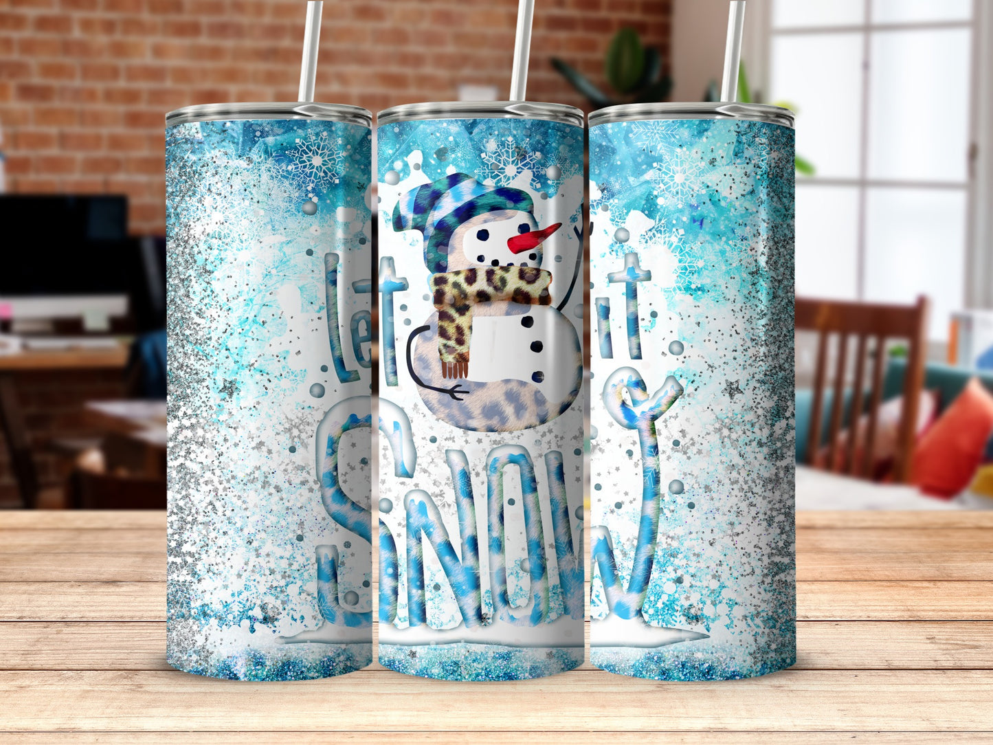 Let it snow tumbler with snowman and snowflakes, on wooden table.