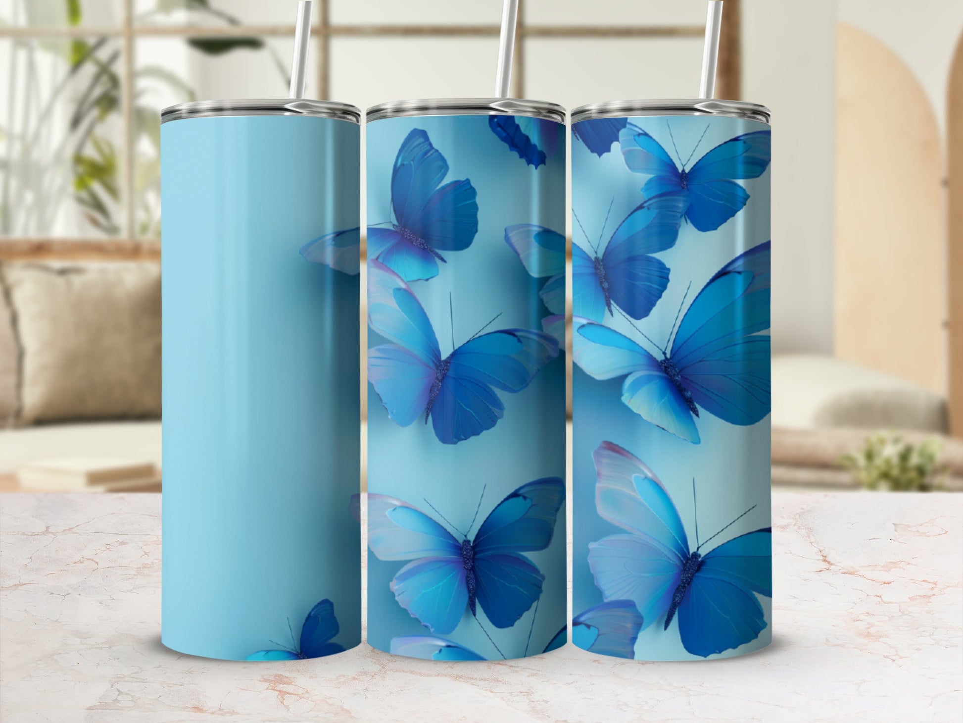 Three light blue tumblers with blue butterfly designs.