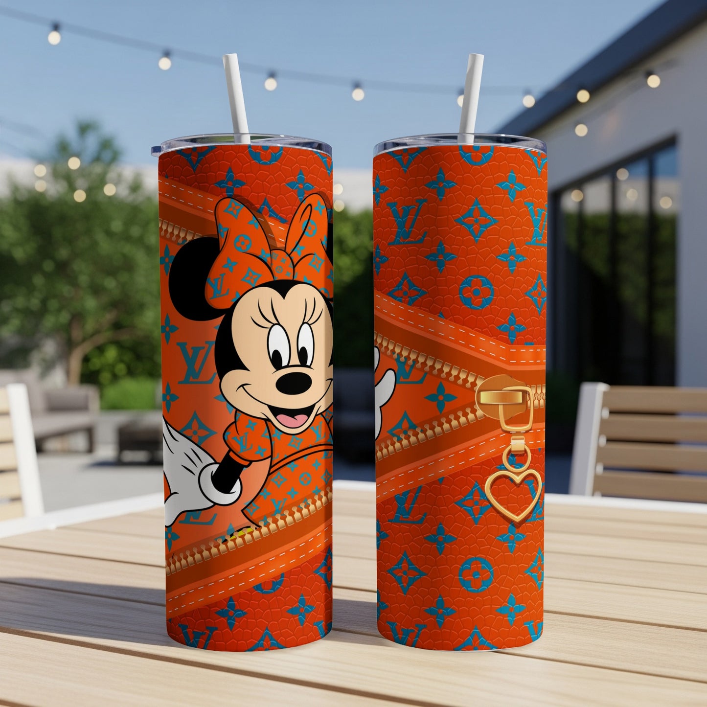 Minnie Mouse in orange designer print on a stainless steel tumbler.
