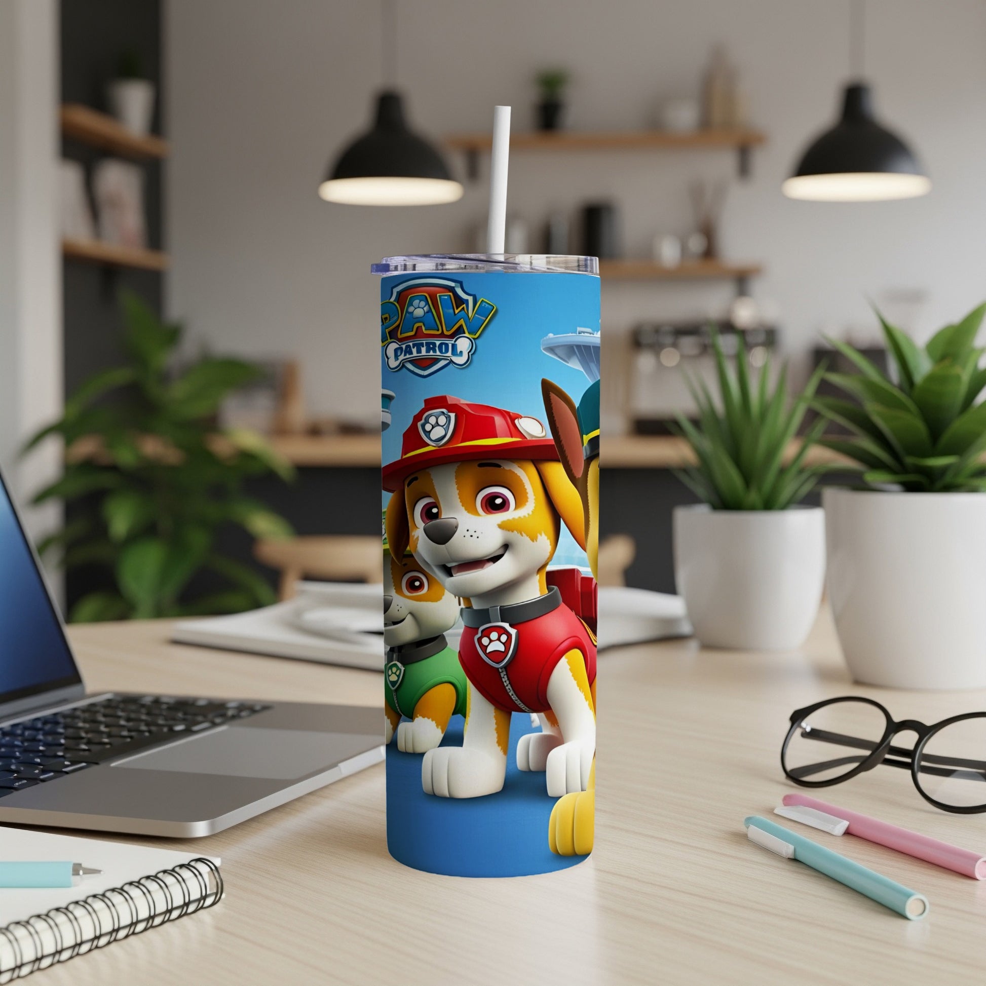 Paw Patrol characters on a blue tumbler with a straw and white lid.