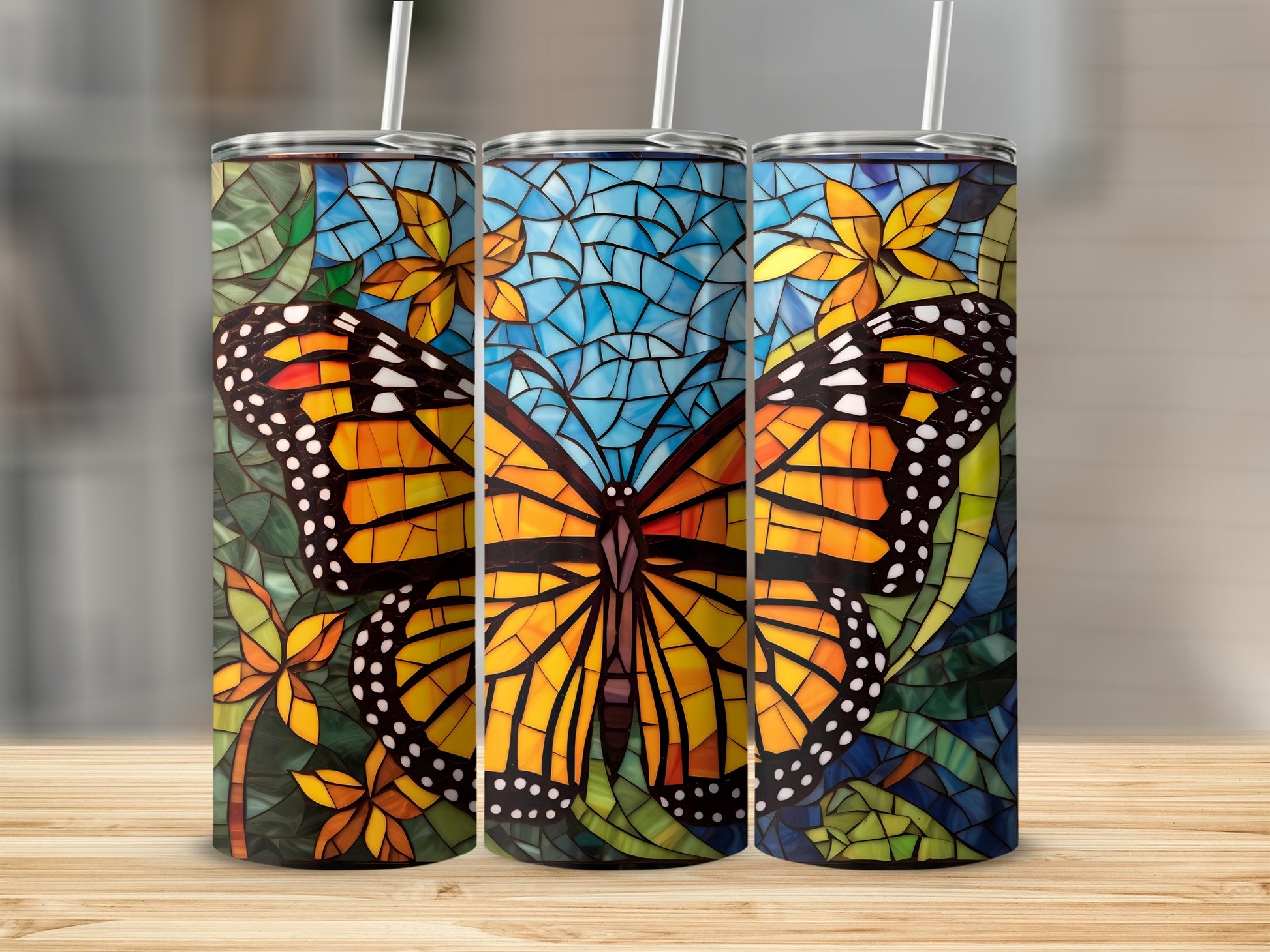 Three tumblers featuring a monarch butterfly and floral stained glass design.