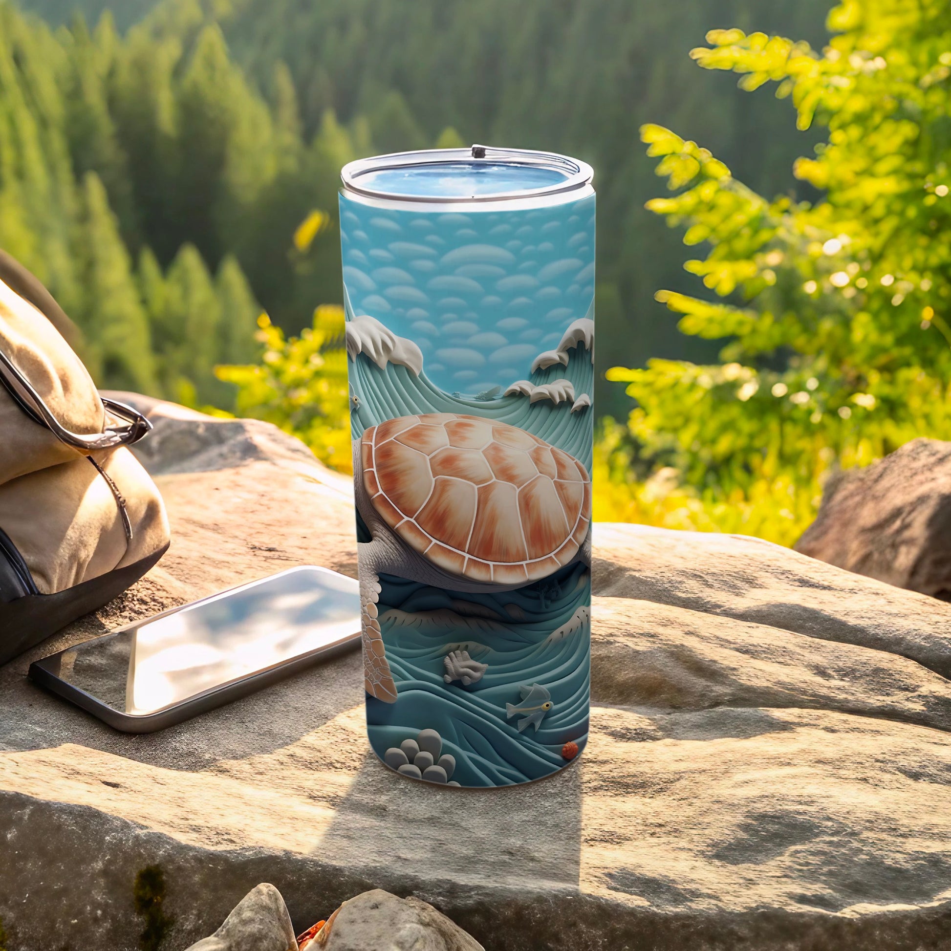 Ocean wave turtle design on a stainless steel tumbler with a backpack and phone.