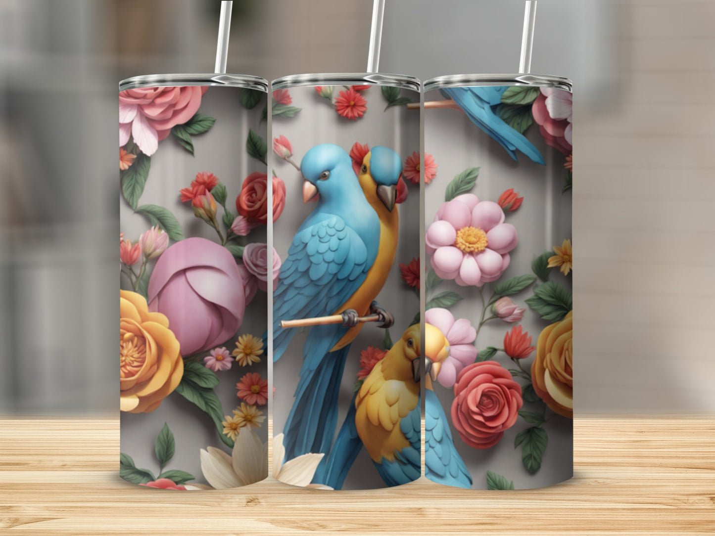 Three tumblers featuring blue and yellow parrots amidst floral designs.