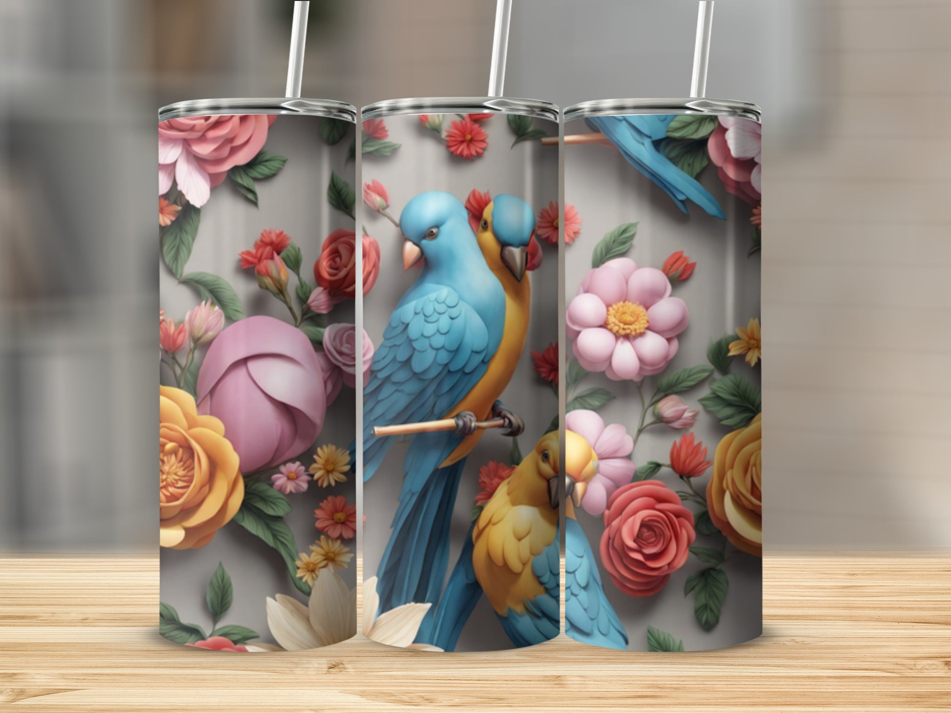 Three tumblers featuring blue and yellow parrots amidst floral designs.