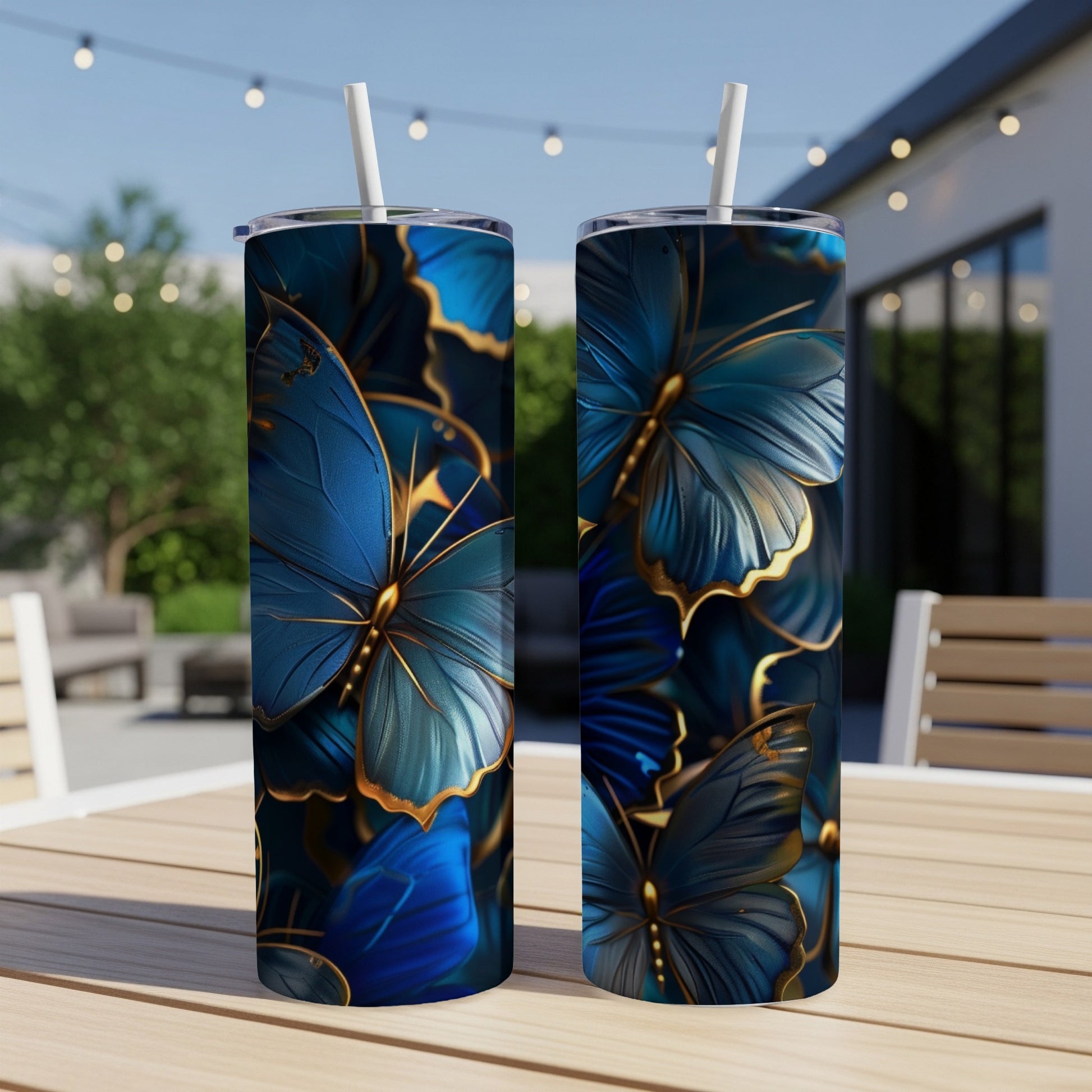 Two blue and gold butterfly tumblers on a table.
