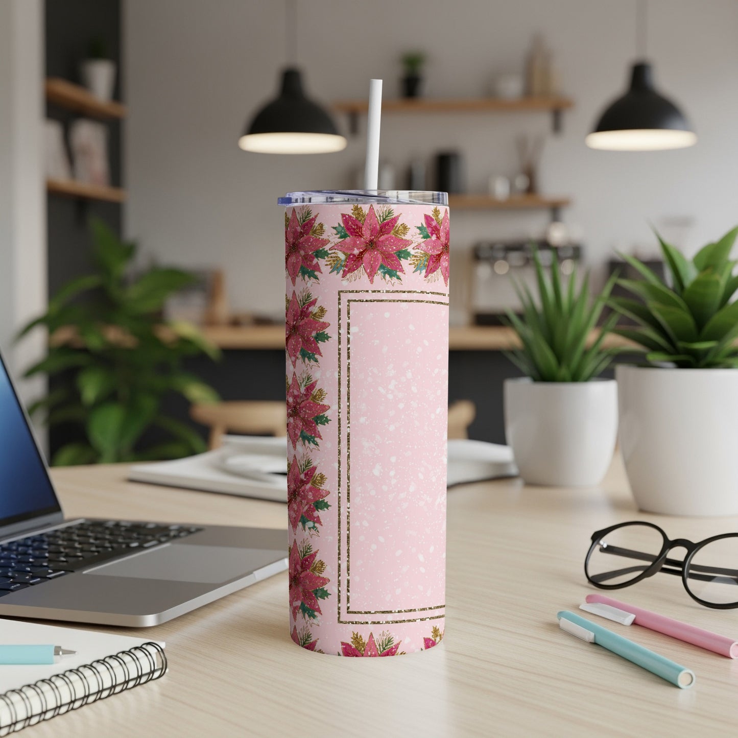 Pink tumbler with poinsettia floral pattern and gold border.