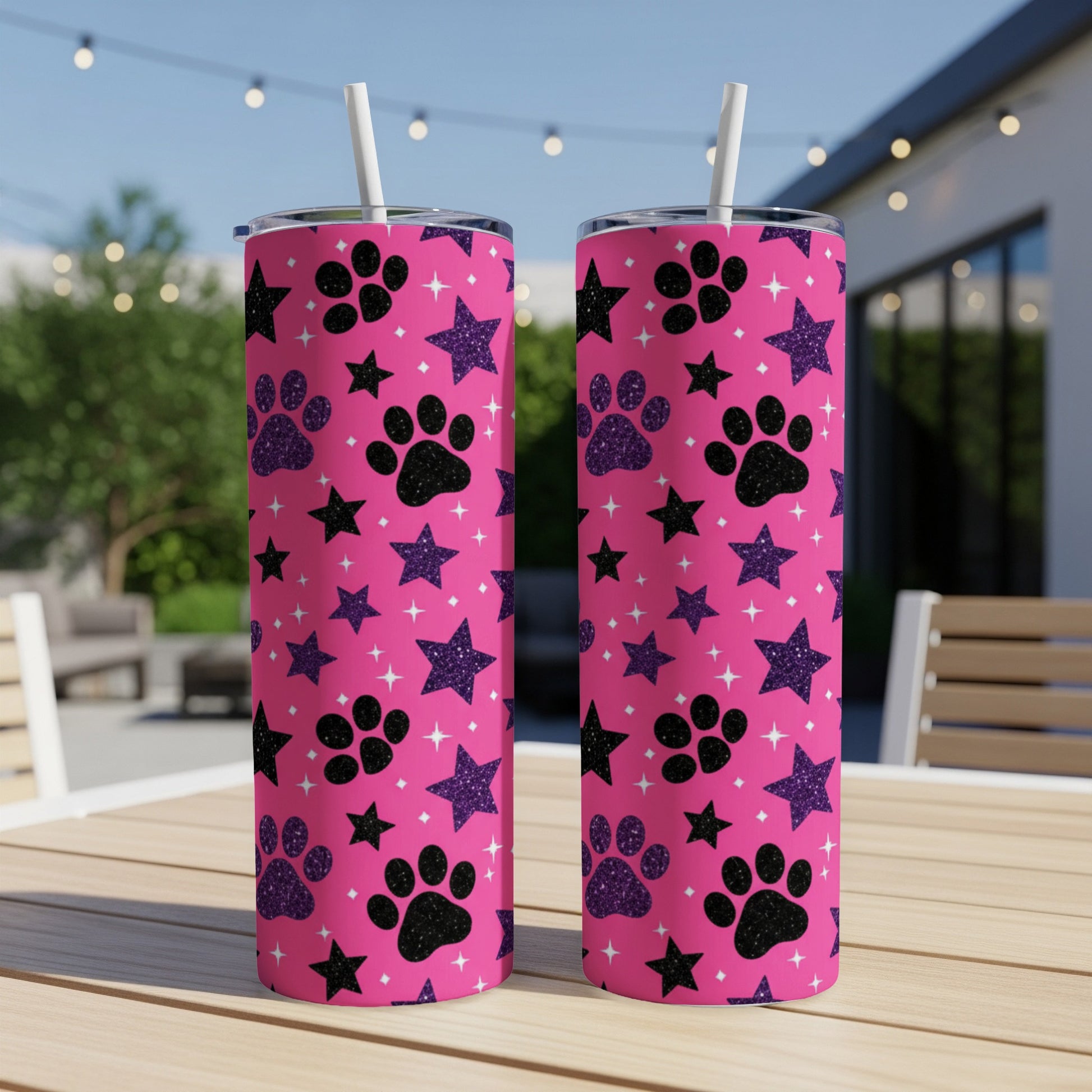 Pink tumbler with paw print and star pattern.