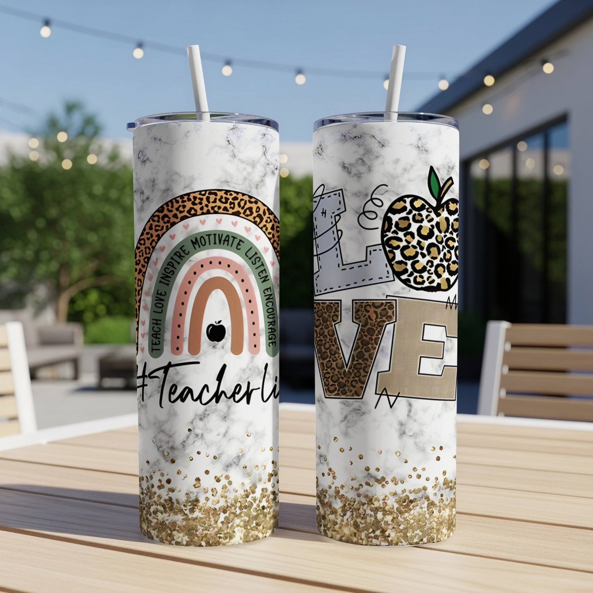 Two skinny tumblers with marble, glitter, and inspirational text and designs.