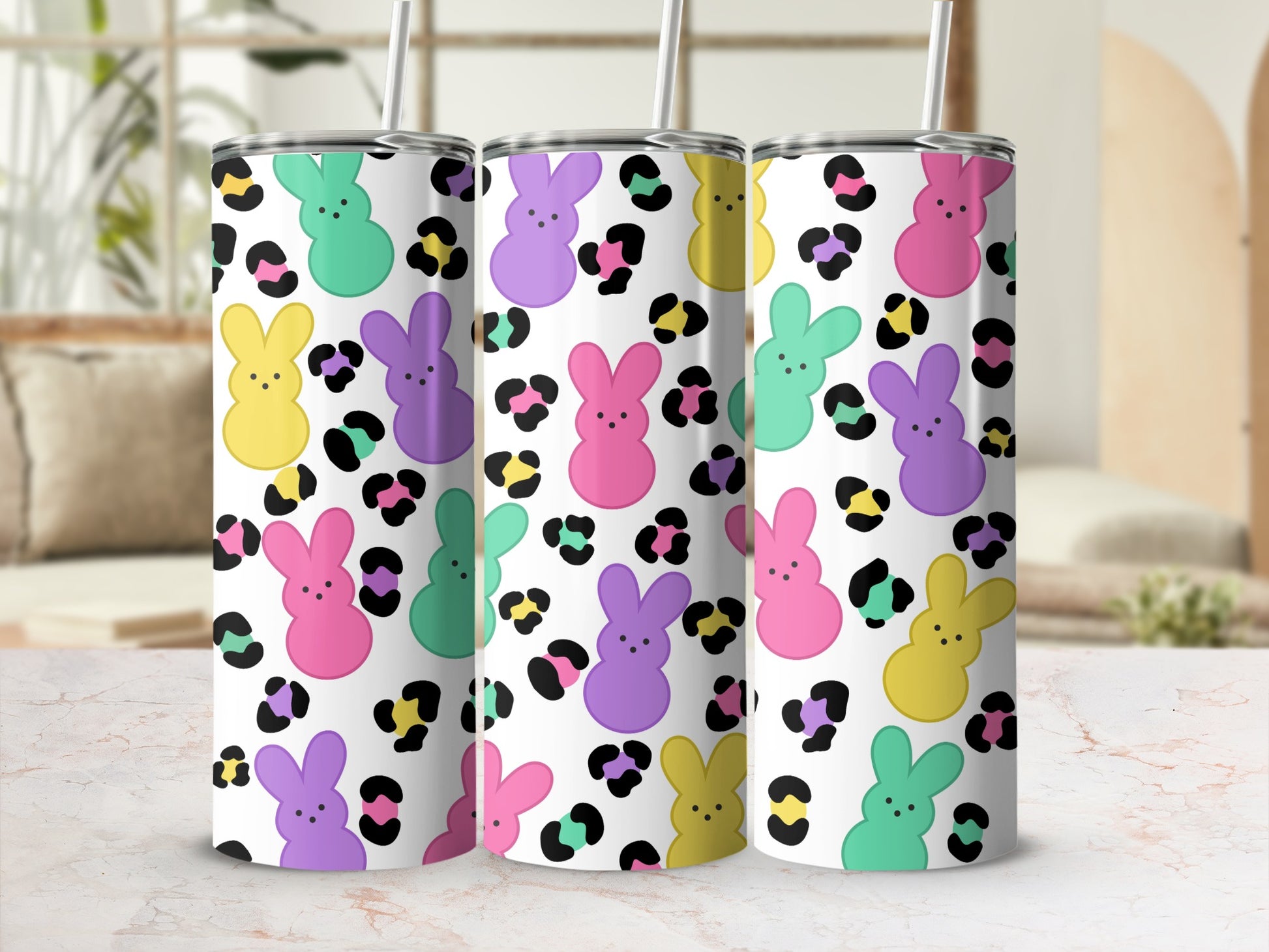 Three tumblers with bunny and leopard print patterns, with straws.