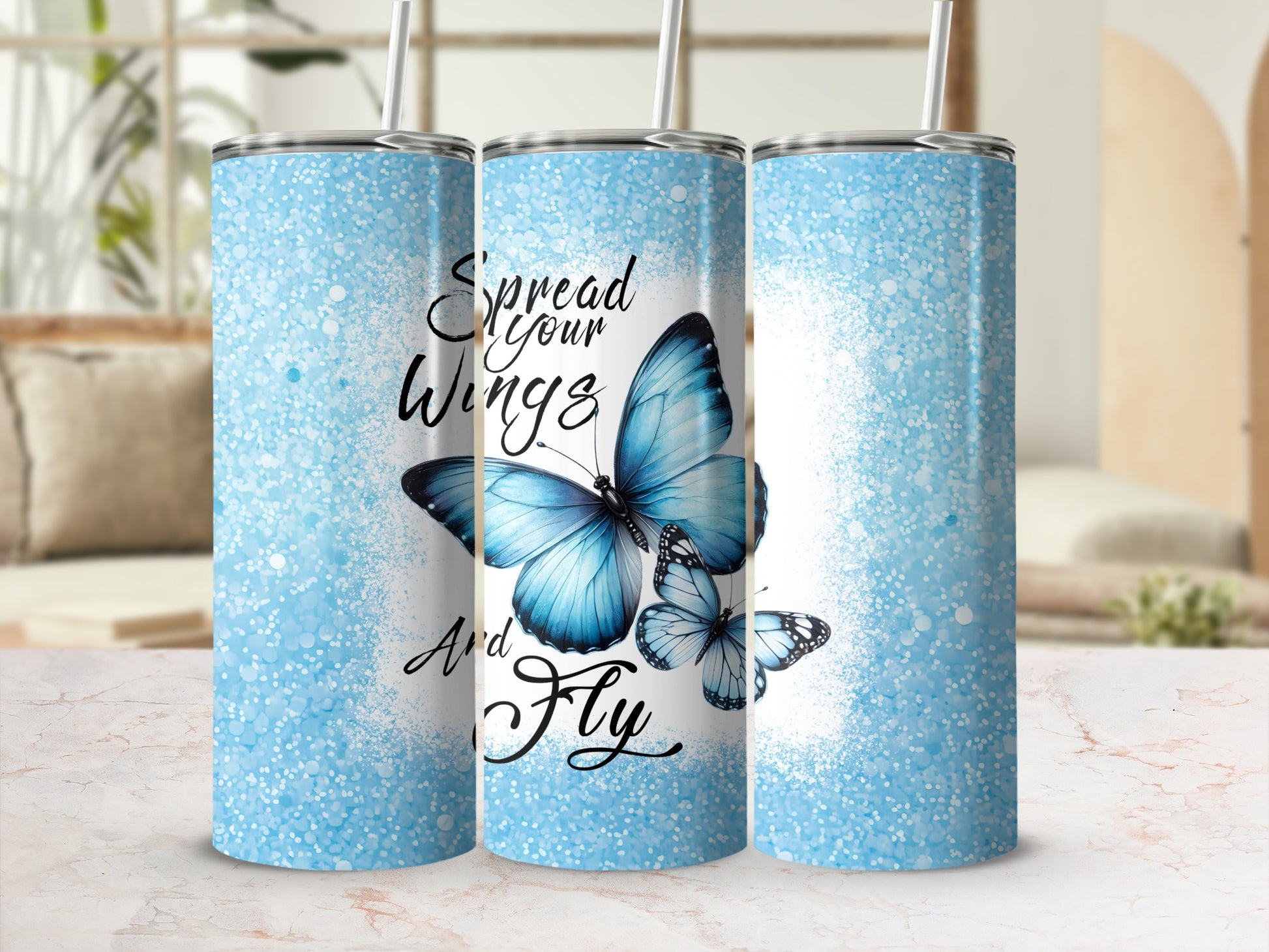 Blue glitter tumbler with "Spread Your Wings And Fly" and butterflies.