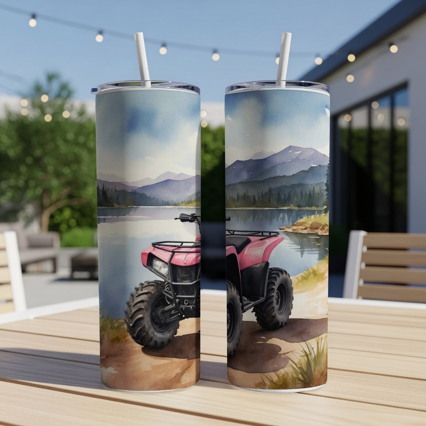 Pink ATV on a lakeside trail, with mountains and trees in the background.