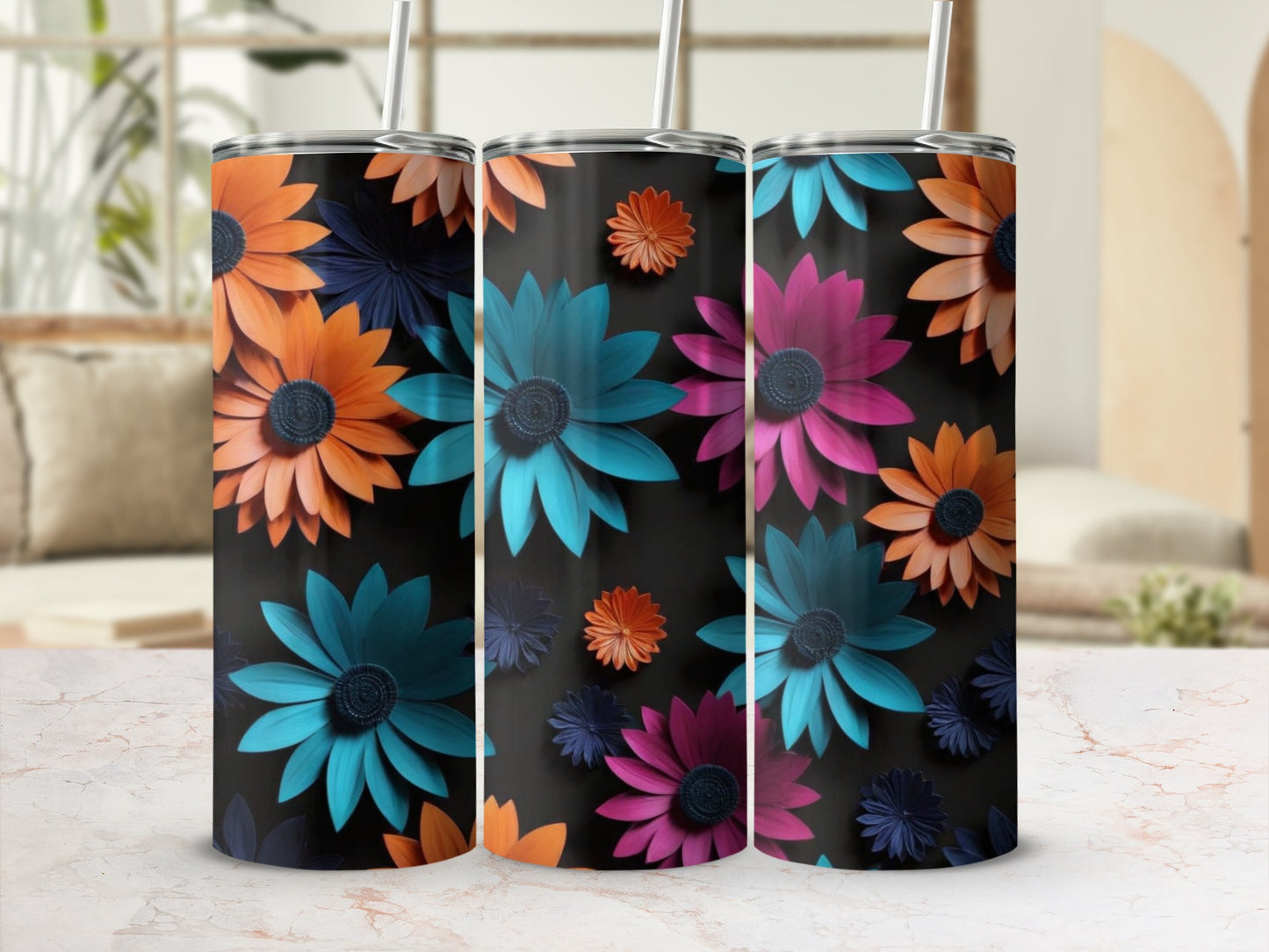 Three tumblers with colorful floral designs on a black background.