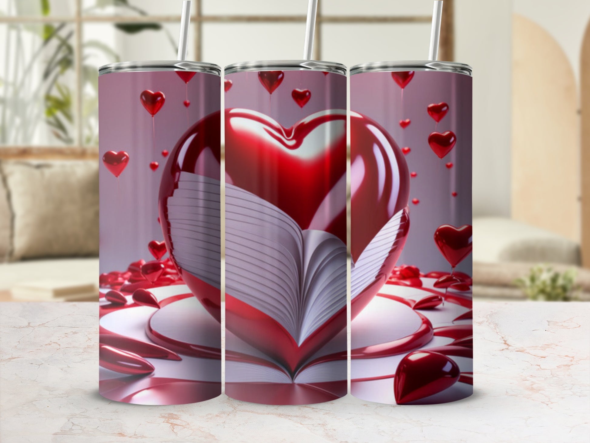 Three tumblers with an open book and heart design on a surface.
