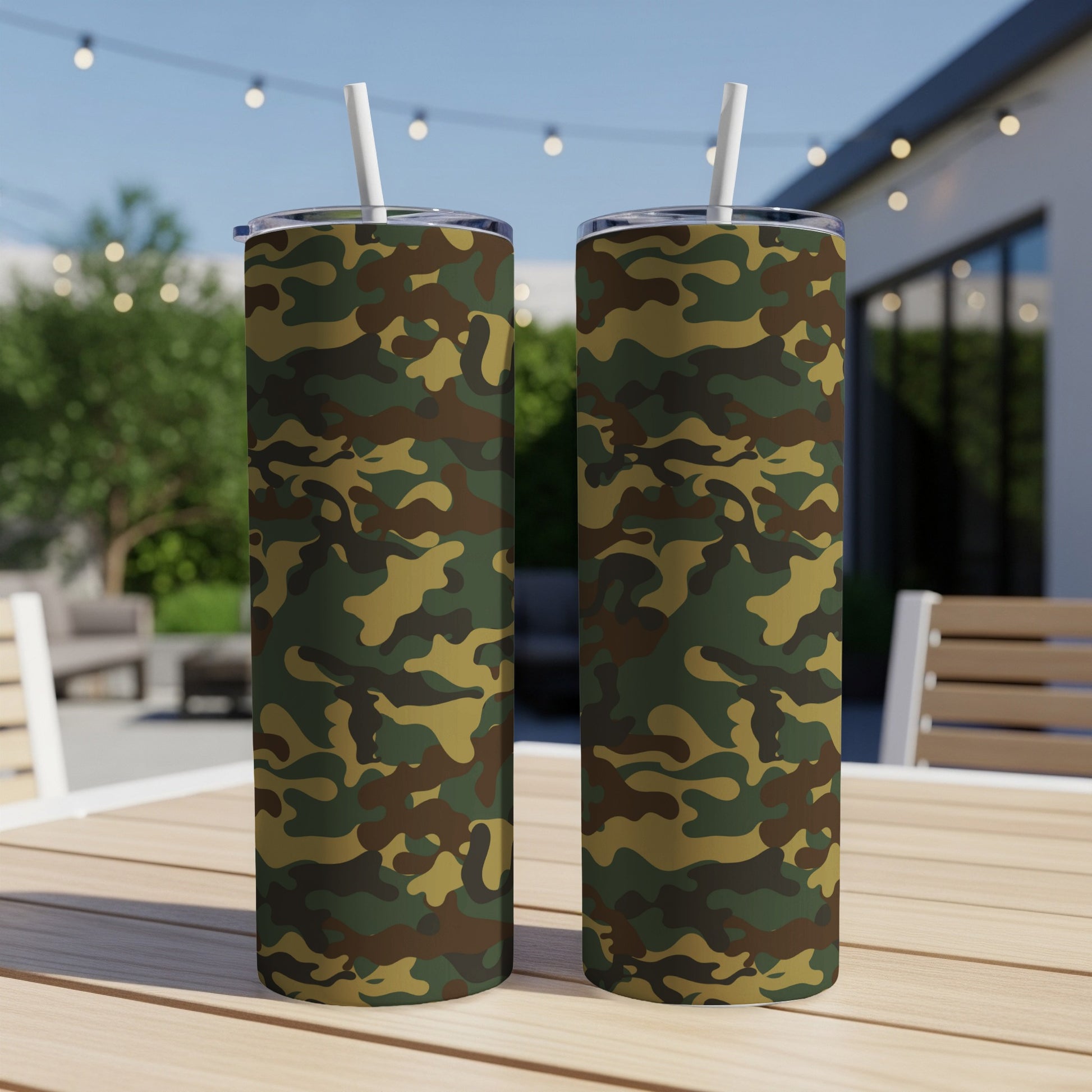 Two tumblers with a green and brown camouflage pattern sit on a wooden table.