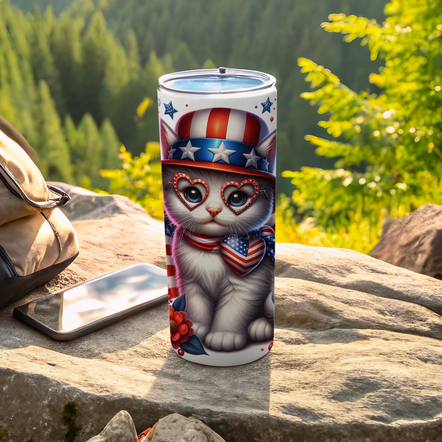 White kitten wearing patriotic hat and heart sunglasses, with American flag scarf.