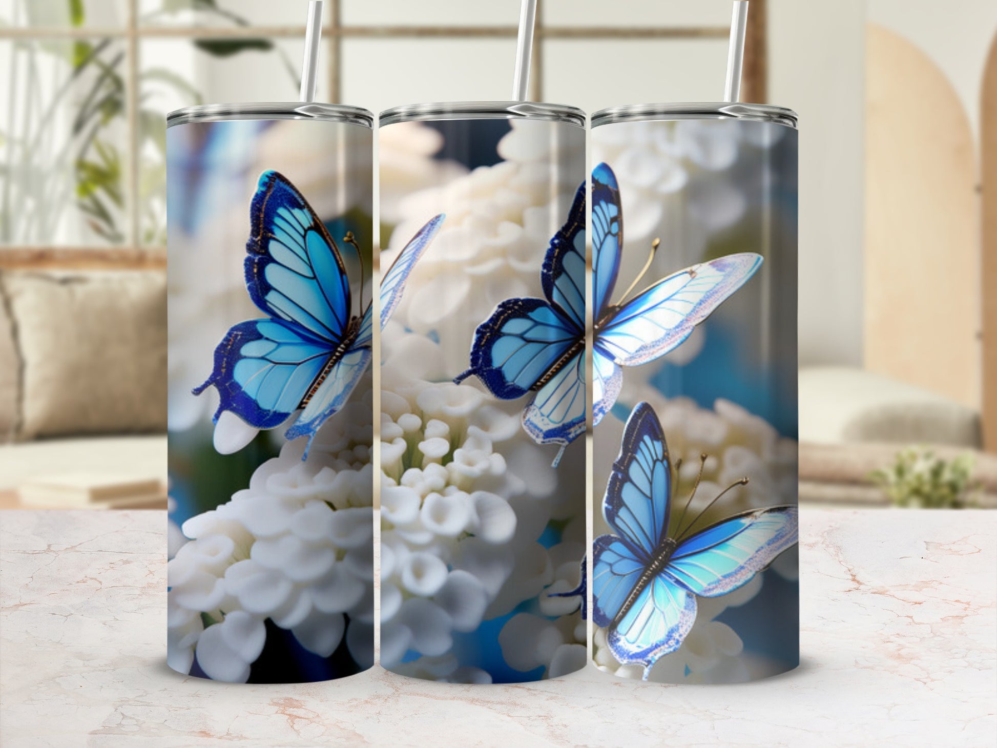Three tumblers feature vibrant blue butterflies on a white floral background.