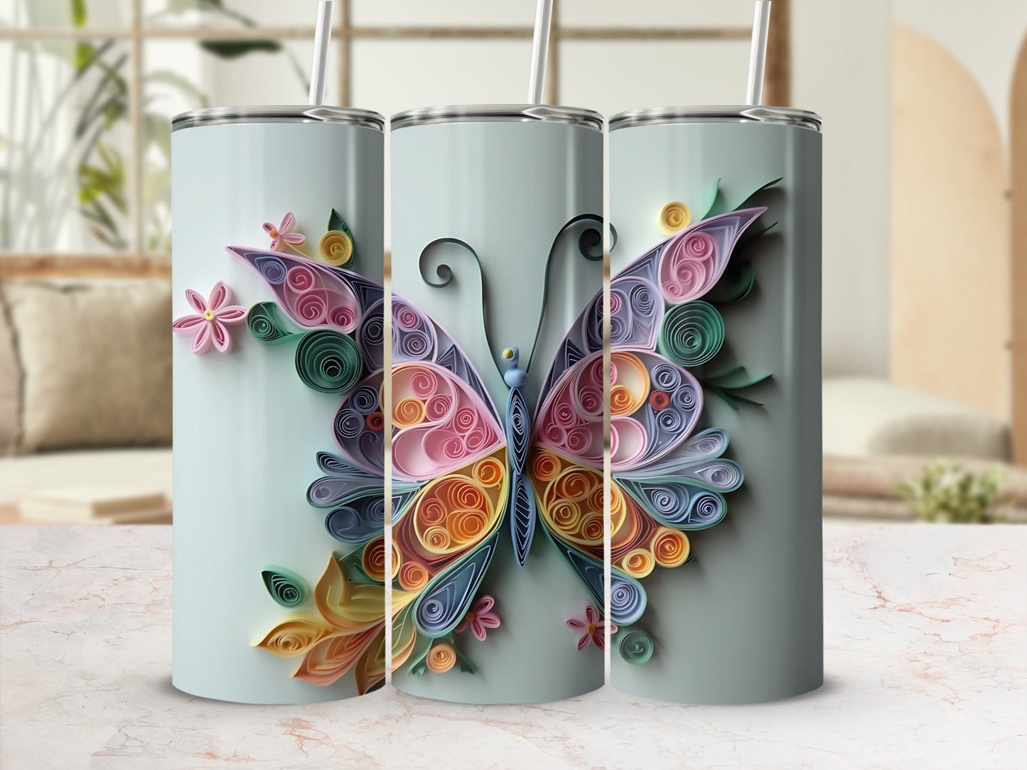 Three tumblers with a pastel butterfly and floral quilled paper design.