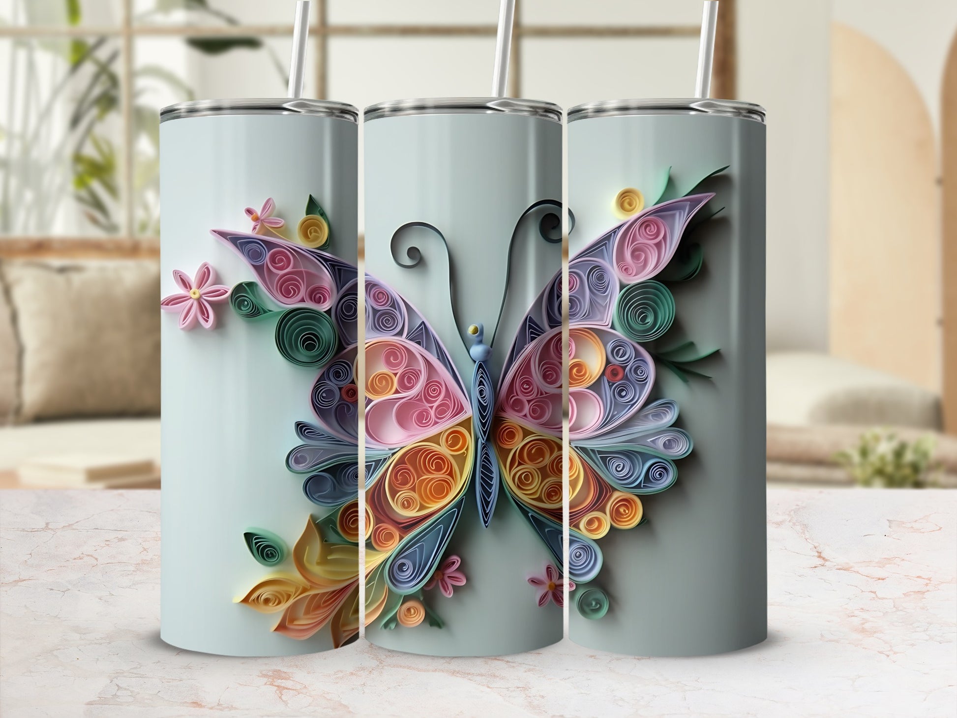 Three tumblers with a pastel butterfly and floral quilled paper design.