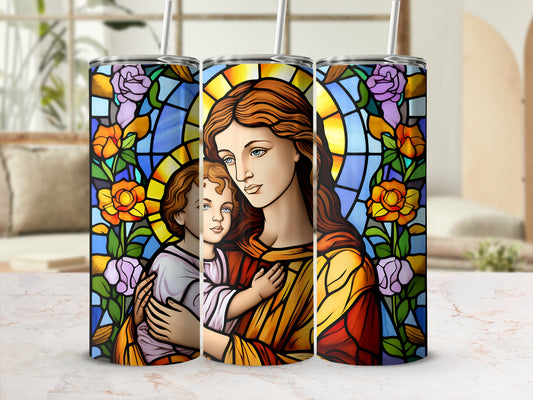 Religious stained glass tumbler with image of Mary holding baby Jesus.