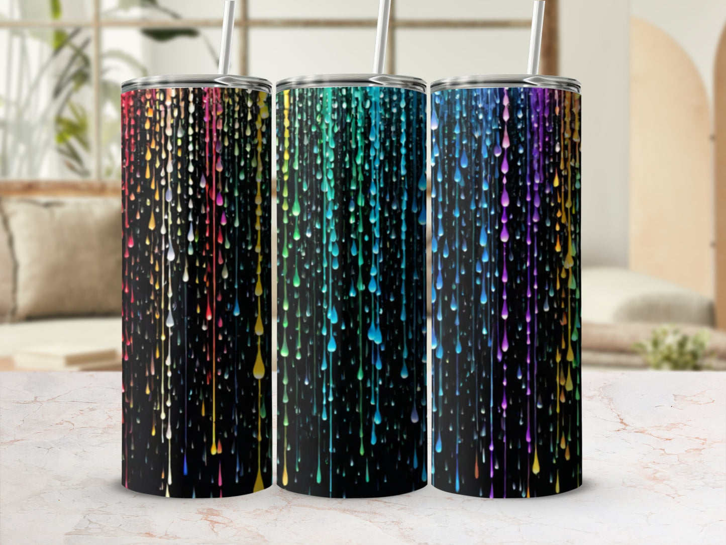 Three tumblers with colorful dripping paint design on black background.
