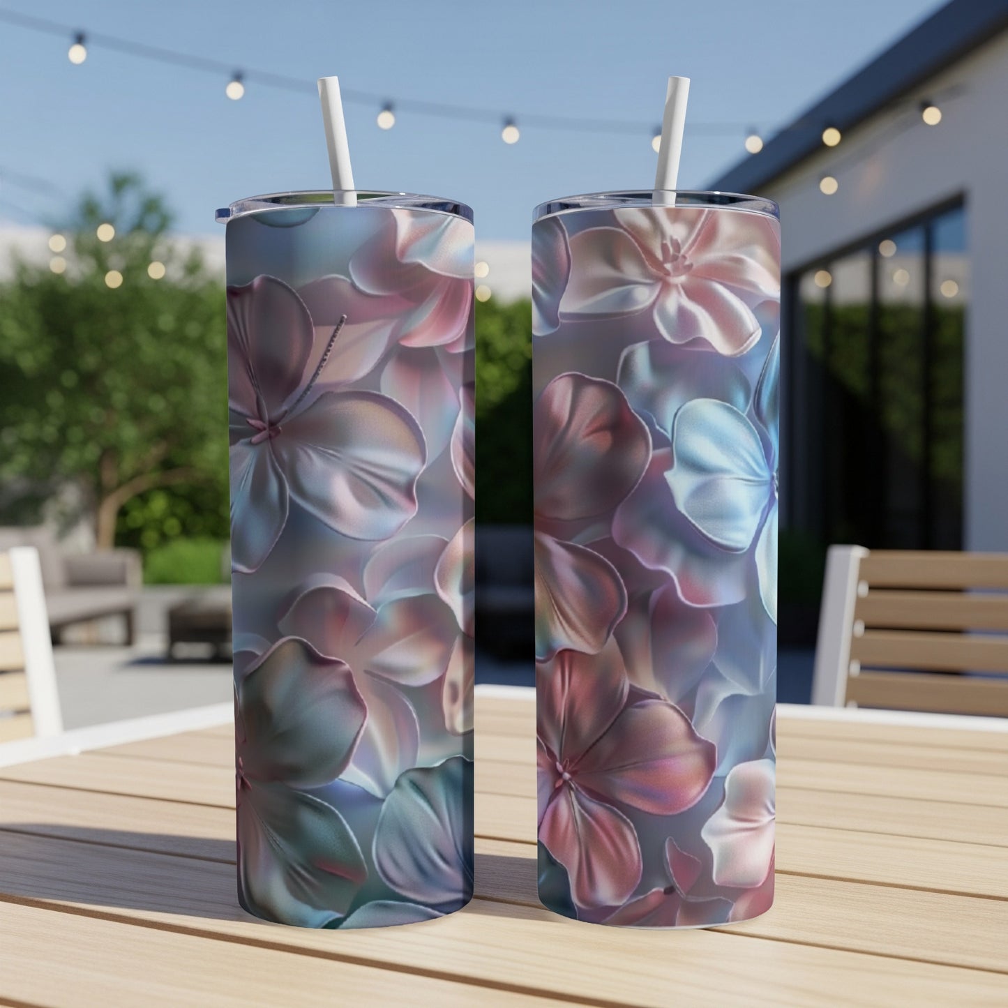 Two tall, insulated tumblers with a floral pattern of pink and blue hibiscus flowers.