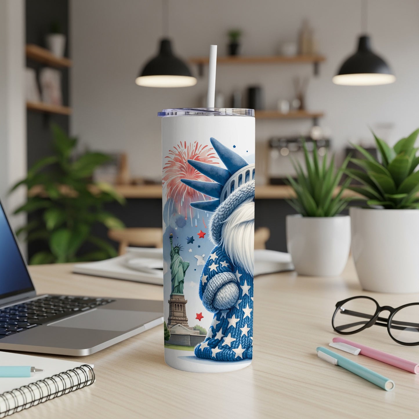 Statue of Liberty gnome with fireworks and stars design on a white tumbler.