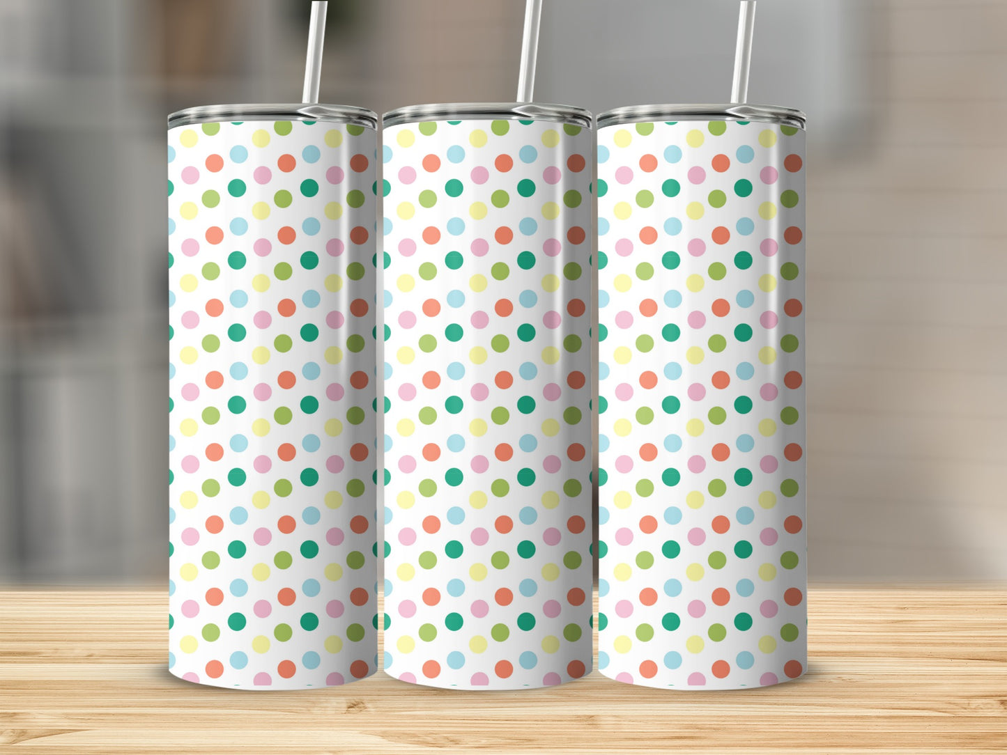 Three tumblers with a white background and colorful polka dots.