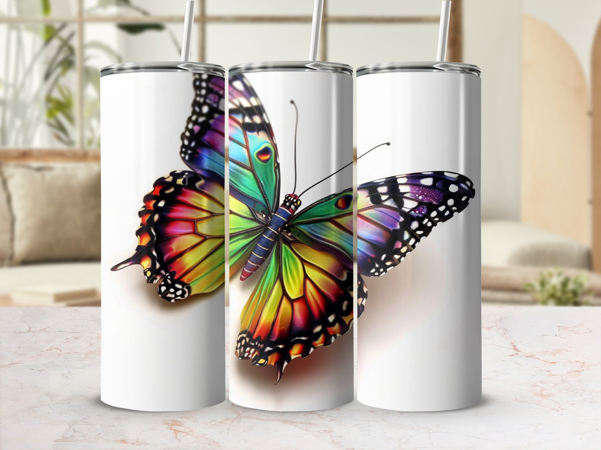 Three white tumblers featuring a colorful butterfly design.